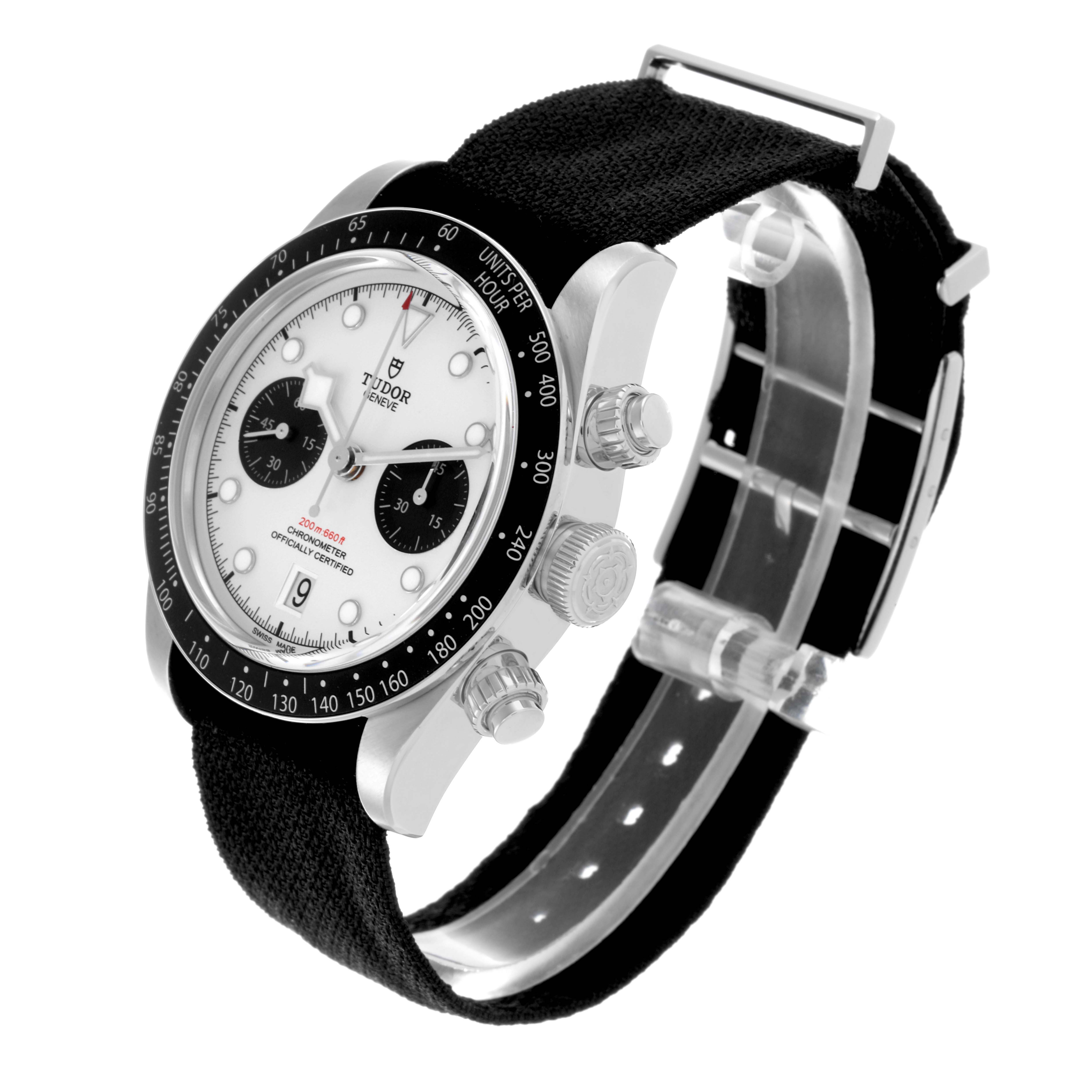 The Tudor Heritage Black Bay watch is shown at an angled side view, highlighting the bezel, dial, pushers, and fabric strap.