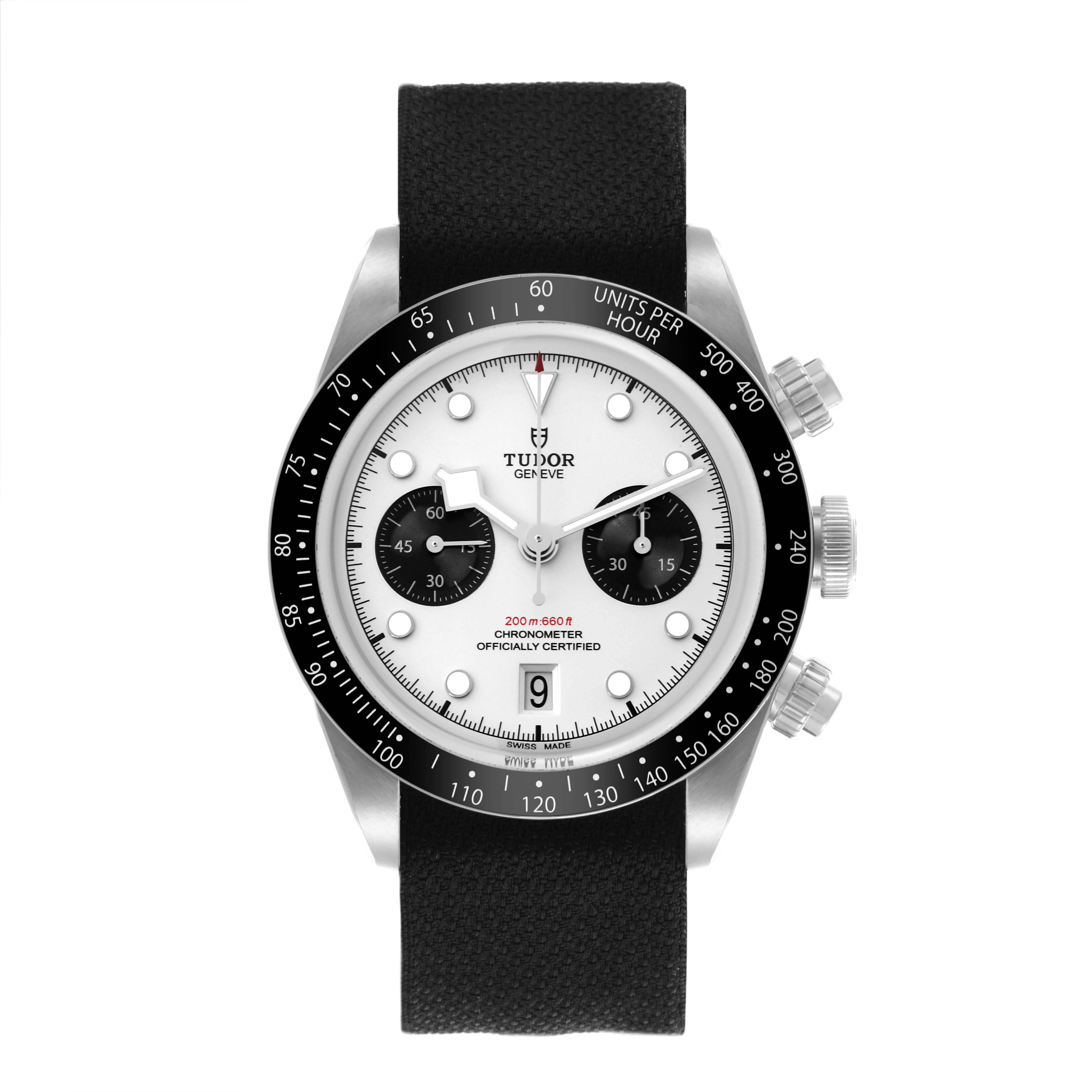 The Tudor Heritage Black Bay watch is shown from a top-down angle, displaying the dial, bezel, and strap.