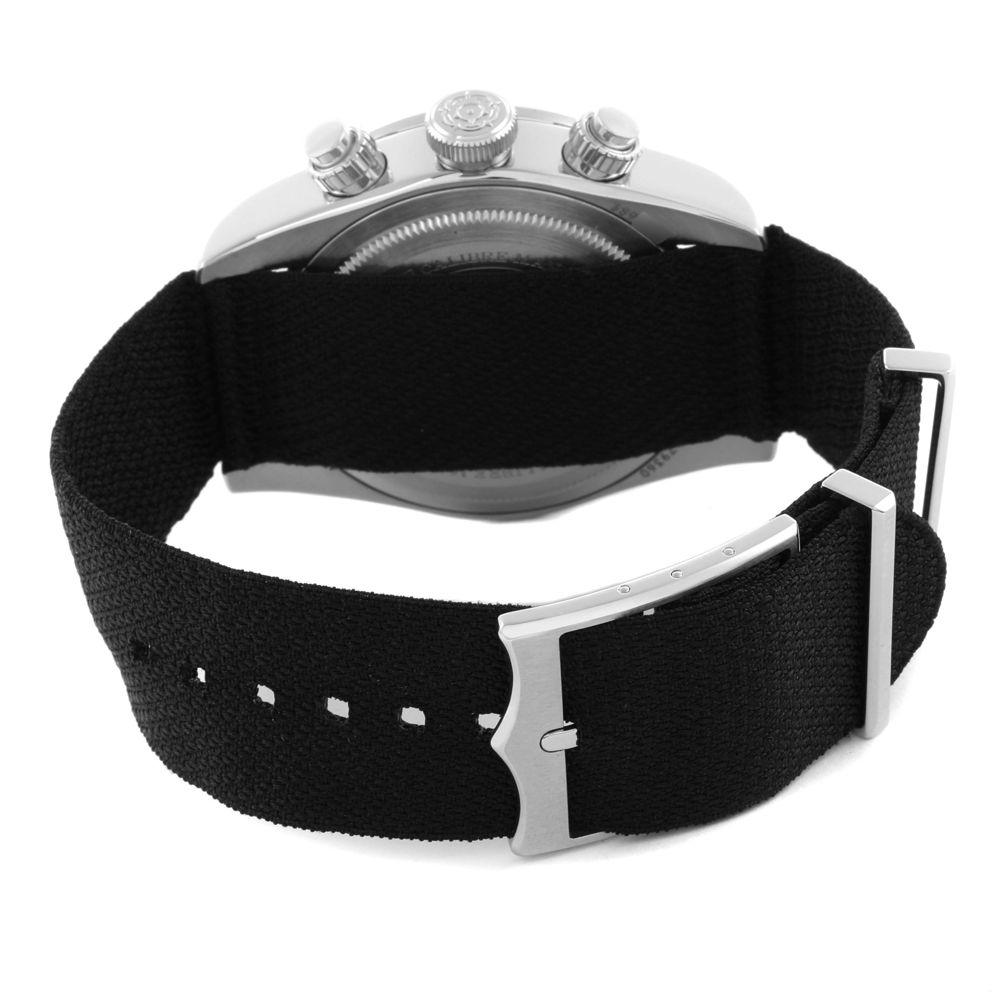 The image shows the back view of a Tudor Heritage Black Bay watch with a focus on the black fabric strap and clasp.