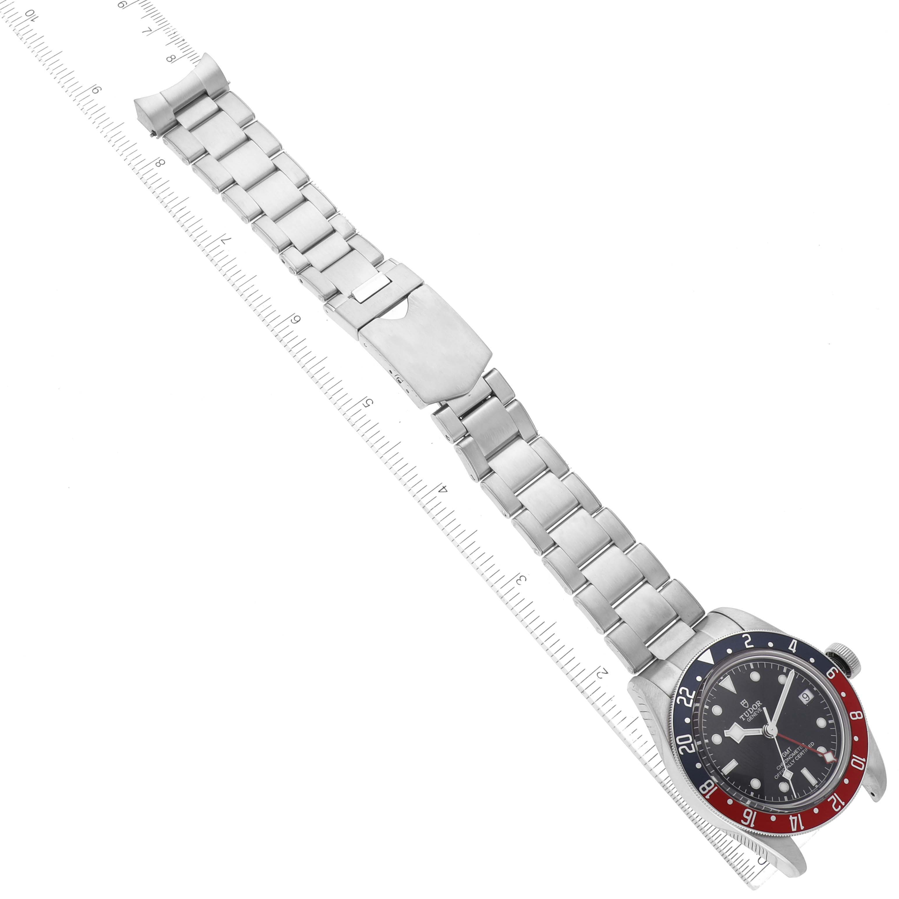 This image shows a Tudor Heritage Black Bay 79830RB Men
s Stainless Steel Black Dial 79830RB Men
s Stainless Steel Black Dial watch laid flat, displaying its bezel, dial, and stainless steel bracelet.