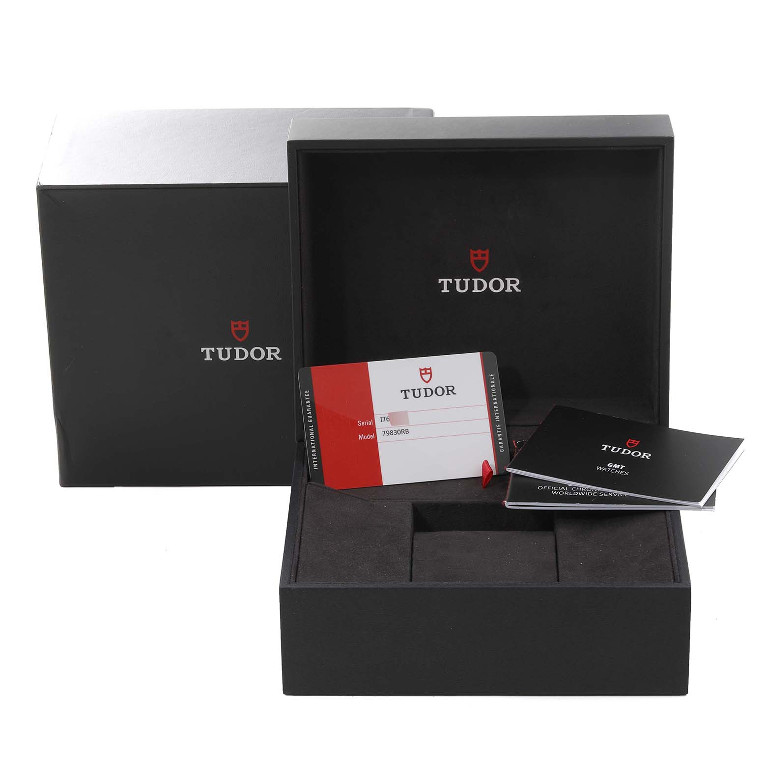 The image shows the packaging and accessories, including a warranty card and booklet, for a Tudor Heritage Black Bay 79830RB Men
s Stainless Steel Black Dial 79830RB Men
s Stainless Steel Black Dial watch.