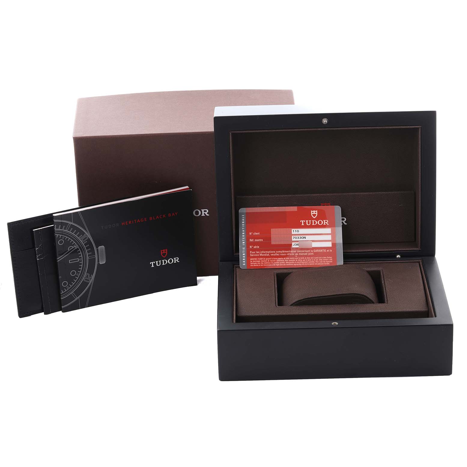 The image shows the Tudor Heritage Chrono 70330N Men's Stainless Steel Grey Dial 70330N Men's Stainless Steel Grey Dial box, warranty card, and booklet from a front angle.