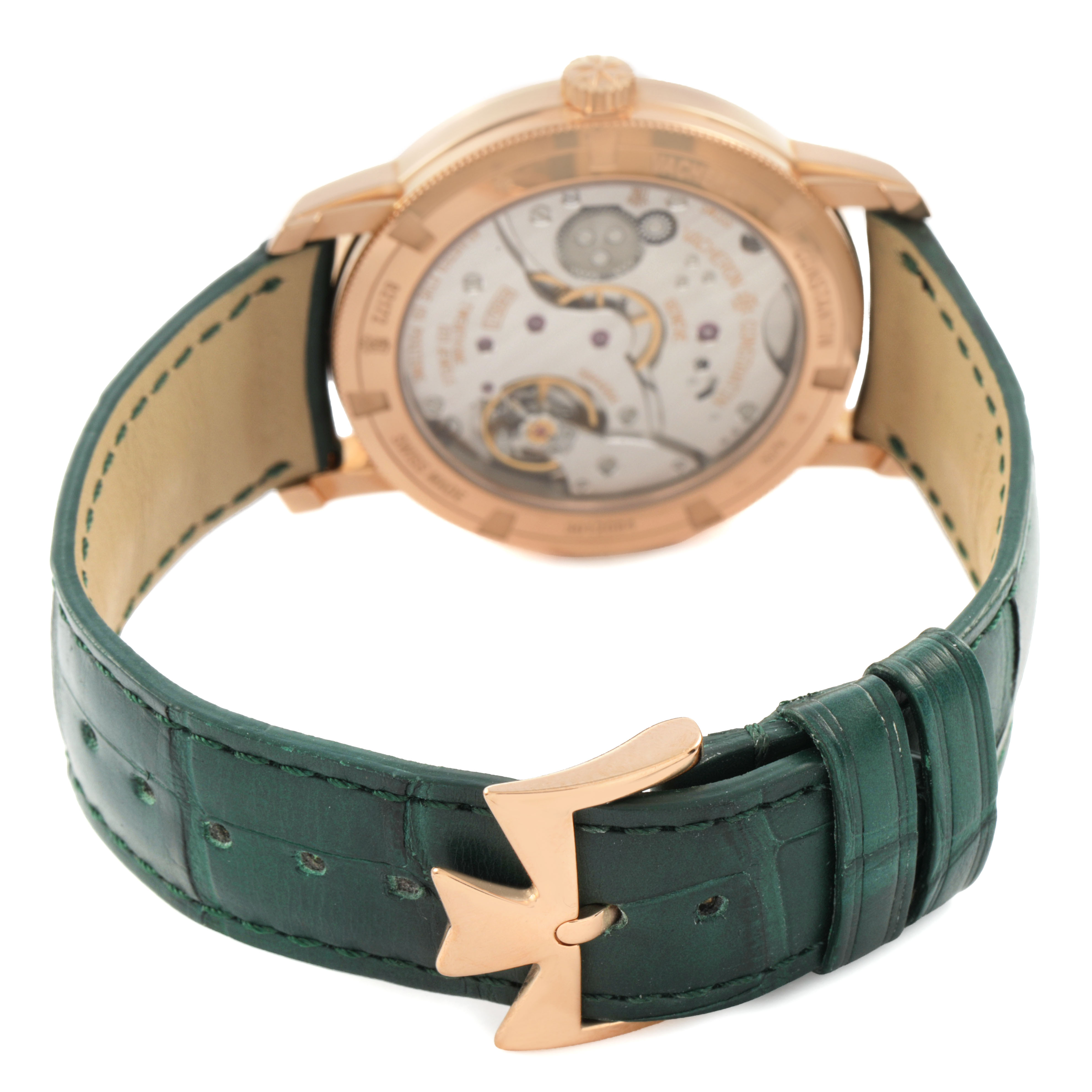 The Vacheron Constantin Traditionnelle 82172/000R-H008 Men's Rose Gold Green Dial watch is shown from the back, highlighting its movement, case, and green leather strap with a rose gold buckle.