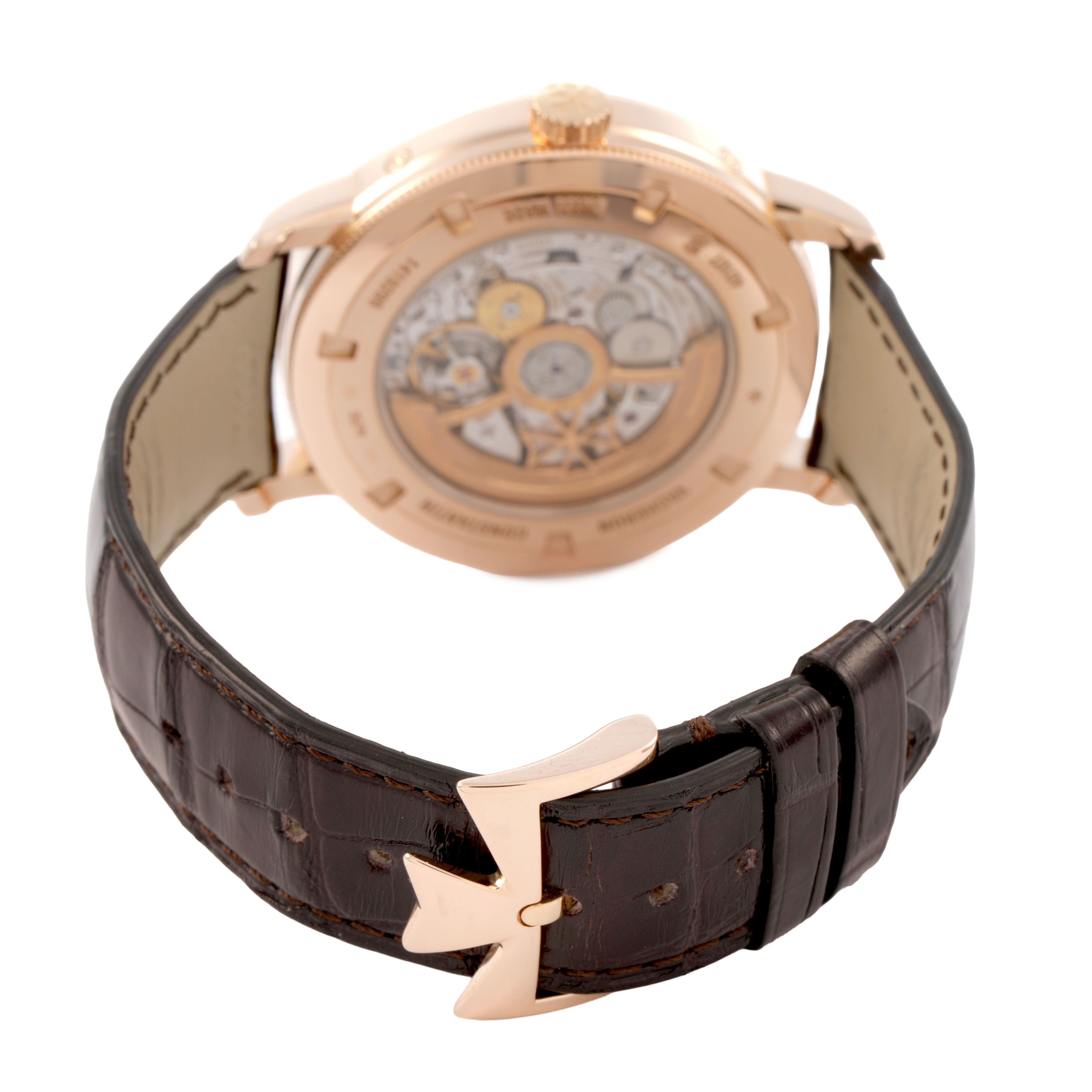 The Vacheron Constantin Traditionnelle 4010T Men's Rose Gold Silver Dial watch is shown from the back, highlighting the case back and leather strap with clasp.