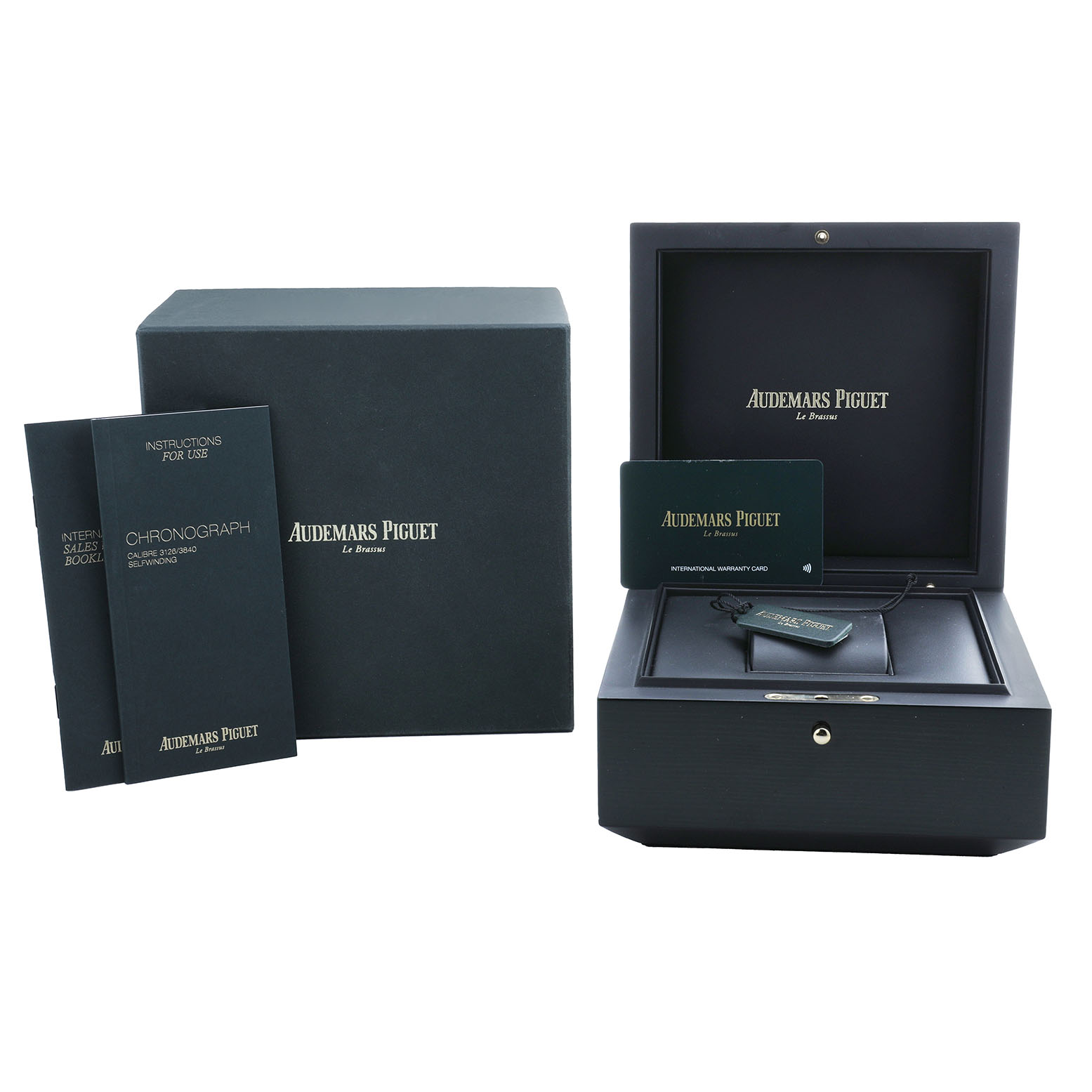 The image shows packaging and accessories for the Audemars Piguet Royal Oak Offshore 26400IO.OO.A004CA.02.A Men's Titanium Grey Dial, including a box, manuals, and a warranty card.
