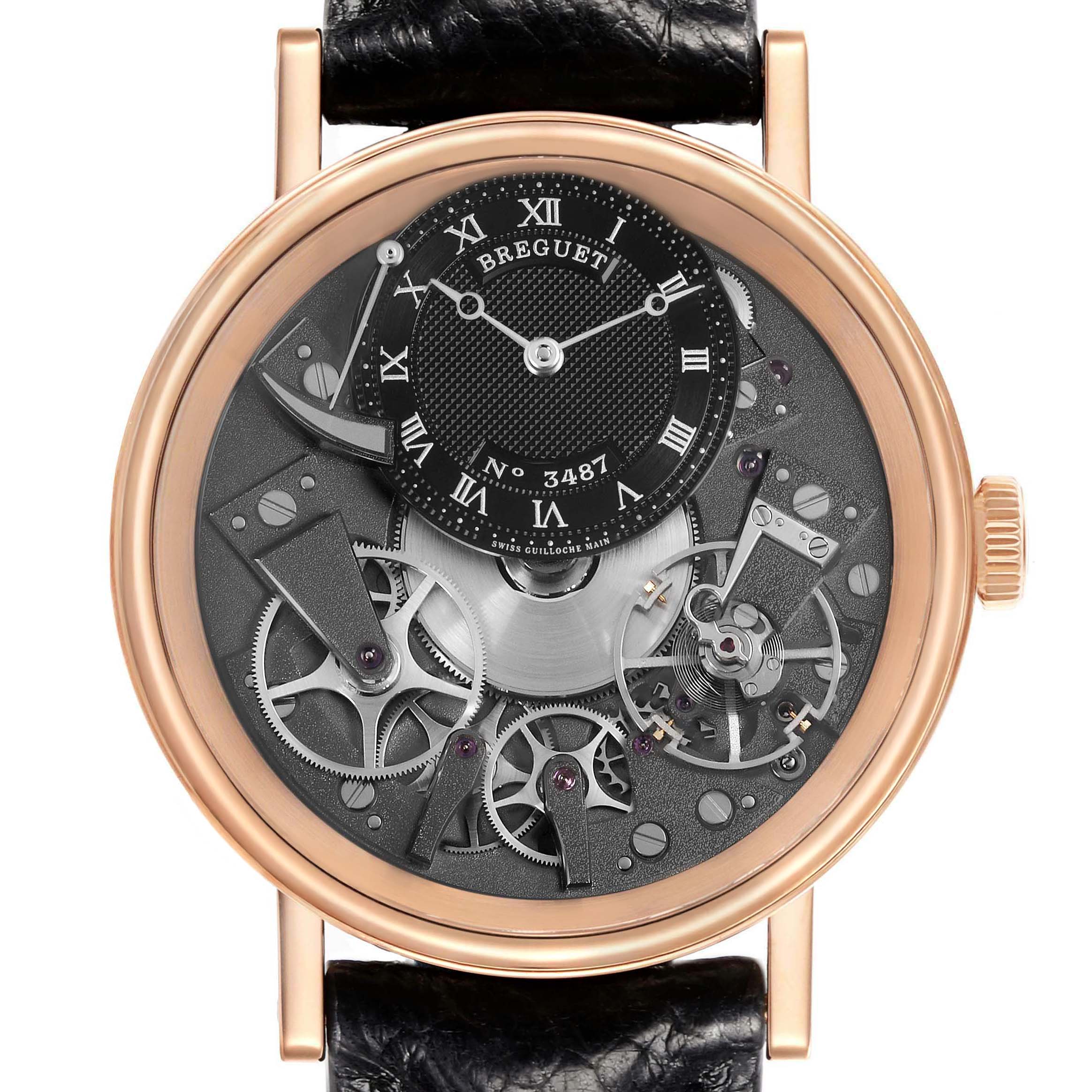The Breguet Tradition 7057BR/G9/9W6 Men's Rose Gold Silver Dial model is shown from the front, highlighting its intricate gears and partially exposed mechanism.