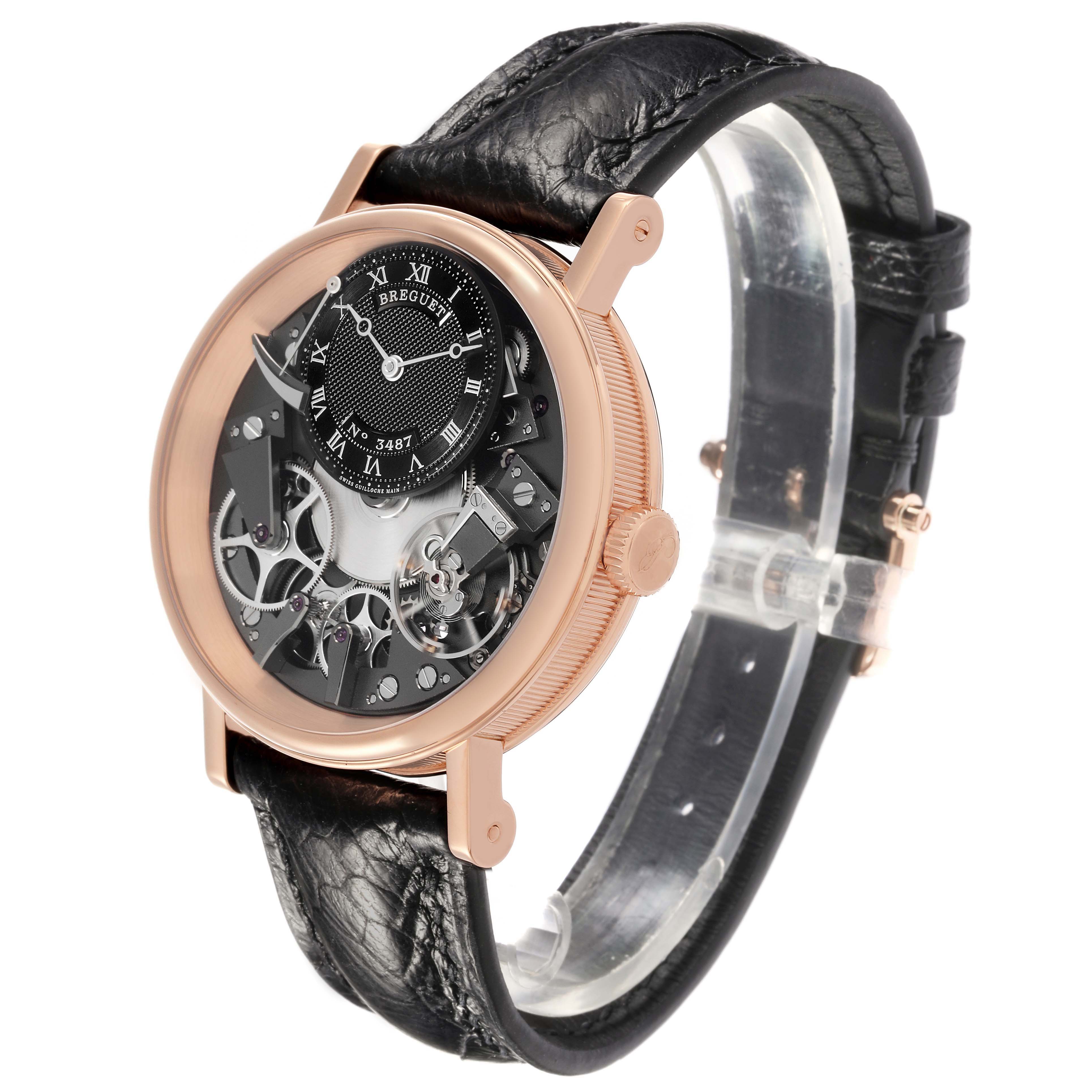 The Breguet Tradition 7057BR/G9/9W6 Men's Rose Gold Silver Dial watch is shown from a three-quarter angle, highlighting its skeleton dial, rose gold case, and black leather strap.