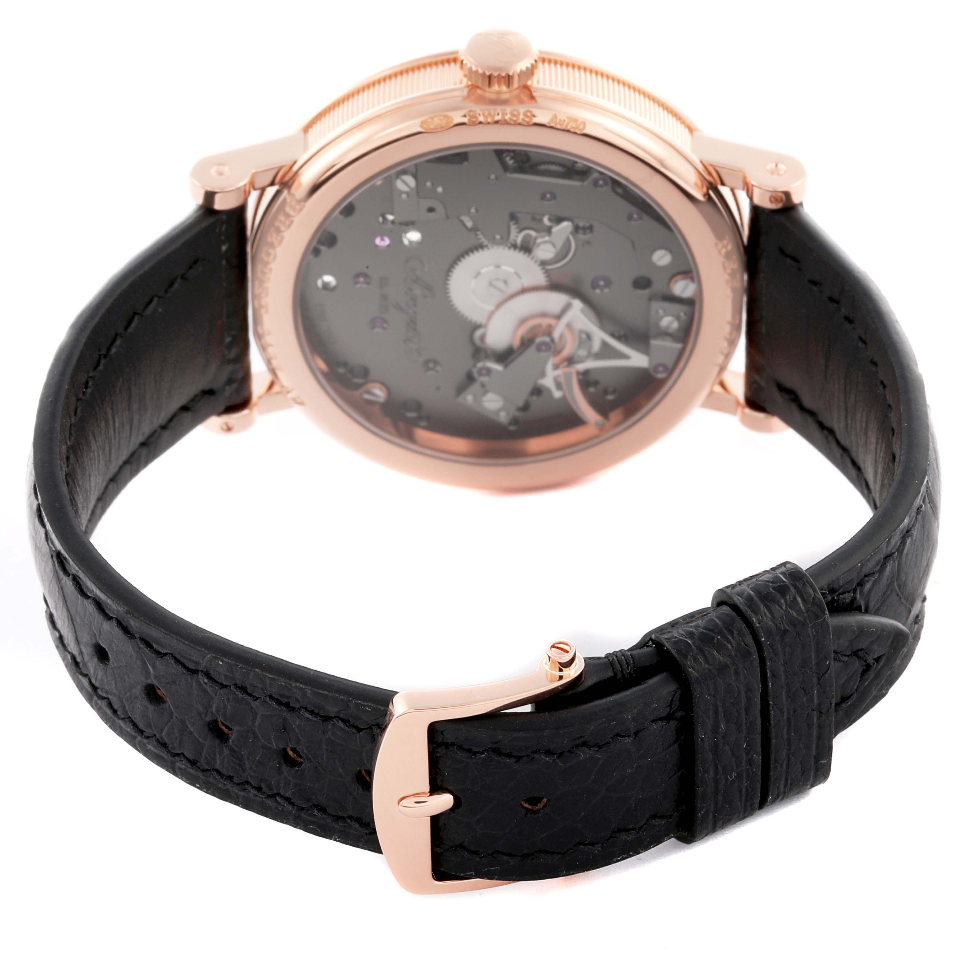 The Breguet Tradition 7057BR/G9/9W6 Men's Rose Gold Silver Dial 7057BR/G9/9W6 Men's Rose Gold Silver Dial watch is shown from an angle highlighting its back case and leather strap with a gold buckle.