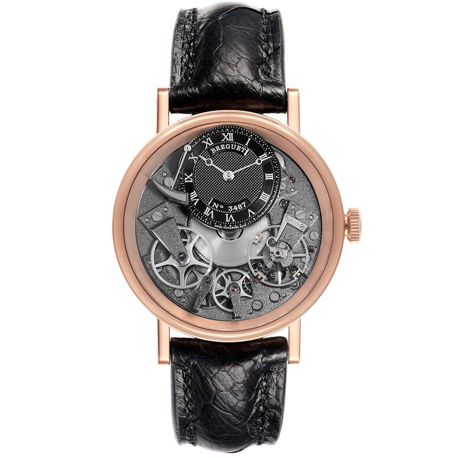 The Breguet Tradition model watch is shown from a front angle, highlighting its intricate dial and black leather strap.