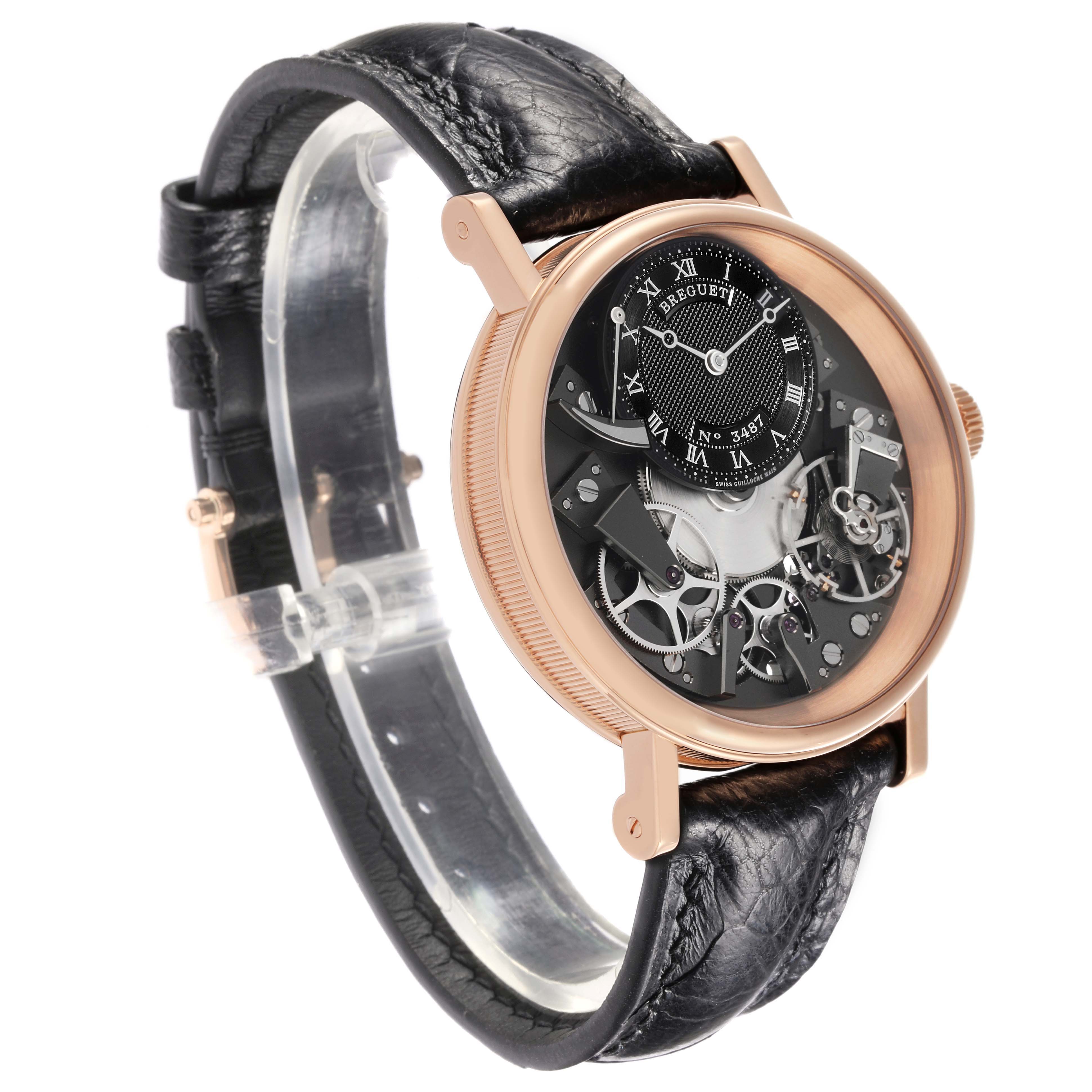 The Breguet Tradition 7057BR/G9/9W6 Men's Rose Gold Silver Dial watch is shown at a three-quarter angle, displaying its intricate skeleton dial and black leather strap.
