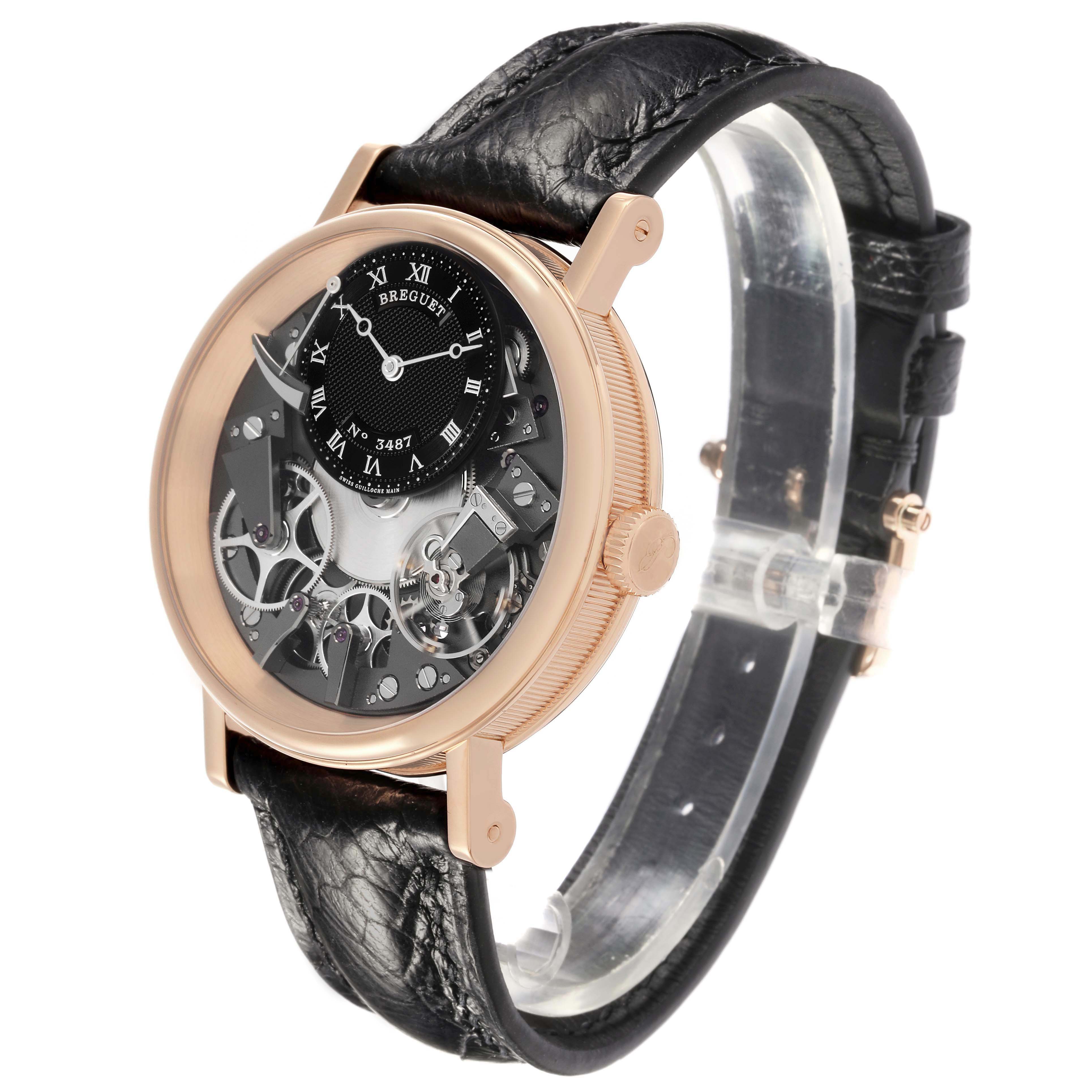 The Breguet Tradition 7057BR/G9/9W6 Men's Rose Gold Silver Dial watch is shown at a three-quarter angle, highlighting its rose gold case, exposed movement, and black leather strap.