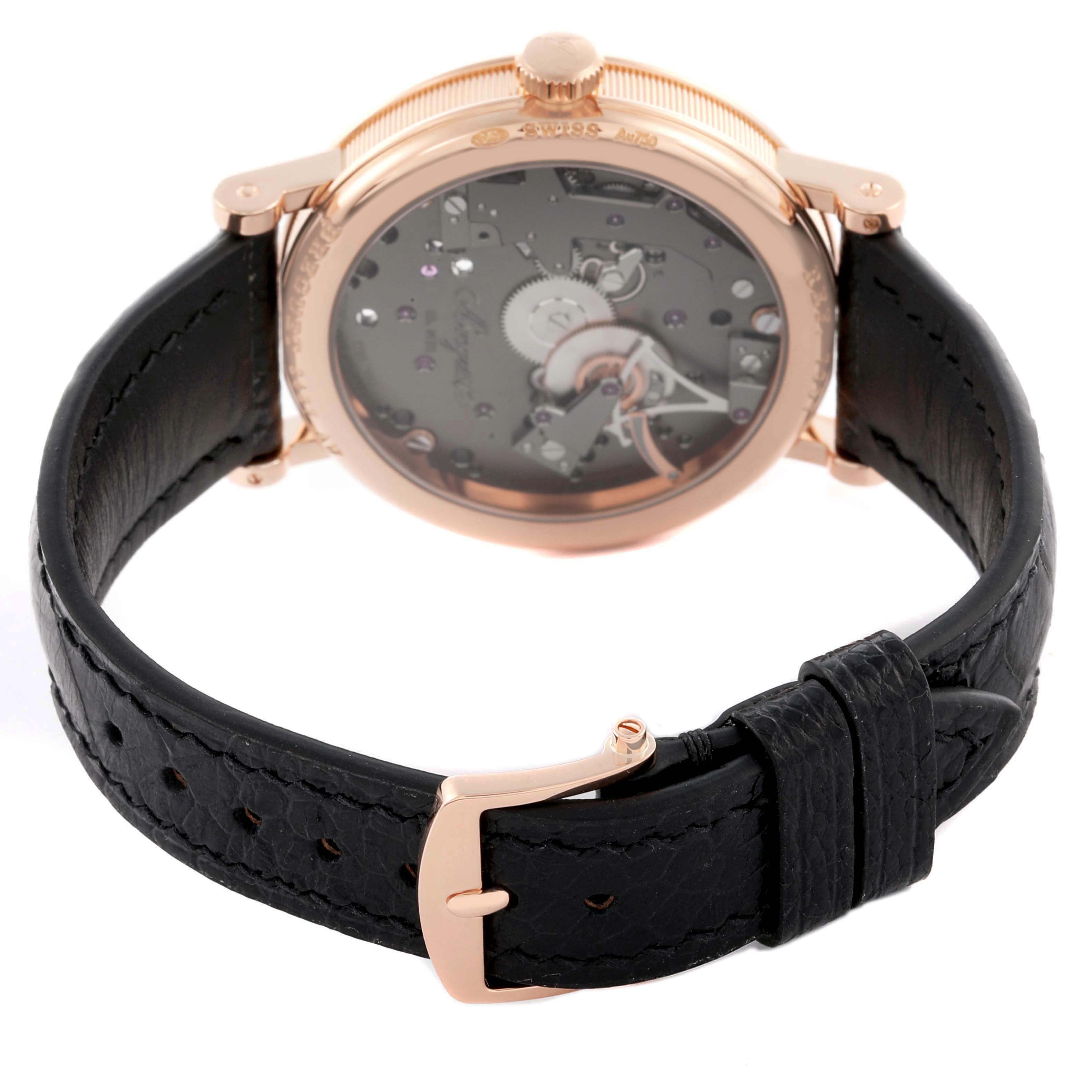 The Breguet Tradition 7057BR/G9/9W6 Men's Rose Gold Silver Dial watch is shown from the rear angle, highlighting the case back, crown, and black leather strap with buckle.