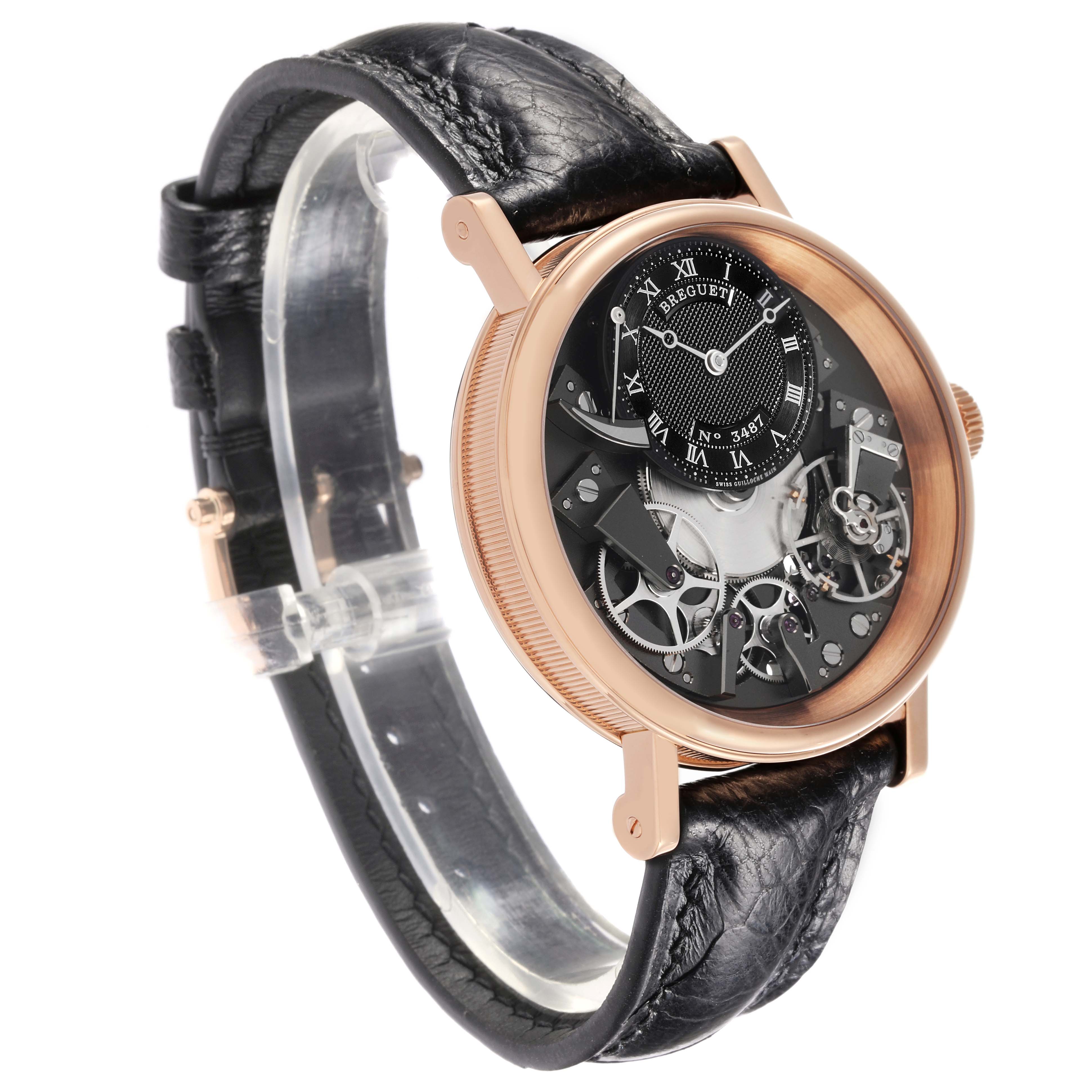 The Breguet Tradition 7057BR/G9/9W6 Men's Rose Gold Silver Dial 7057BR/G9/9W6 Men's Rose Gold Silver Dial watch is shown at an angled side view, displaying its intricate open face and leather strap.