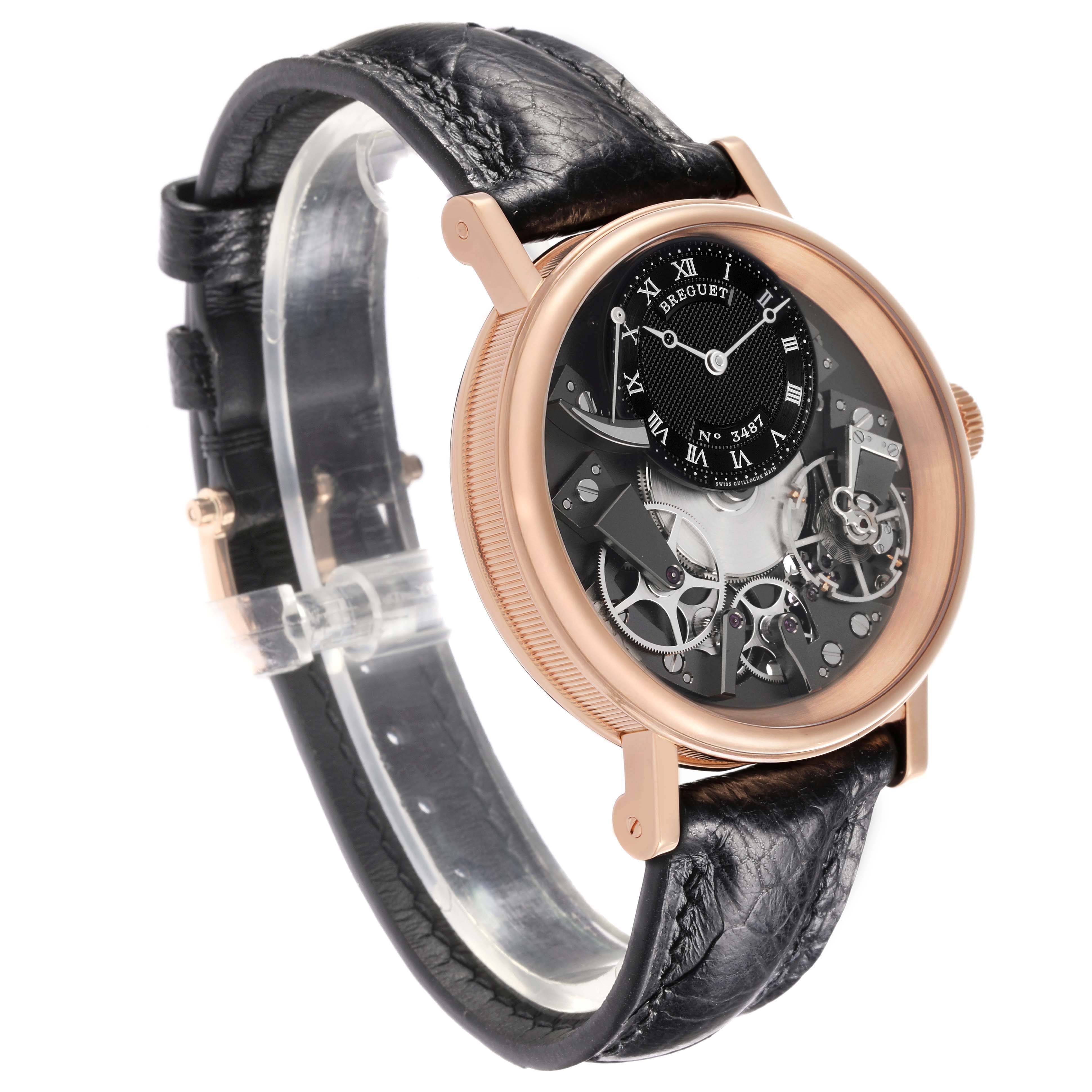The Breguet Tradition 7057BR/G9/9W6 Men's Rose Gold Silver Dial watch is shown at a slight side angle, highlighting its intricate movement and black leather strap.