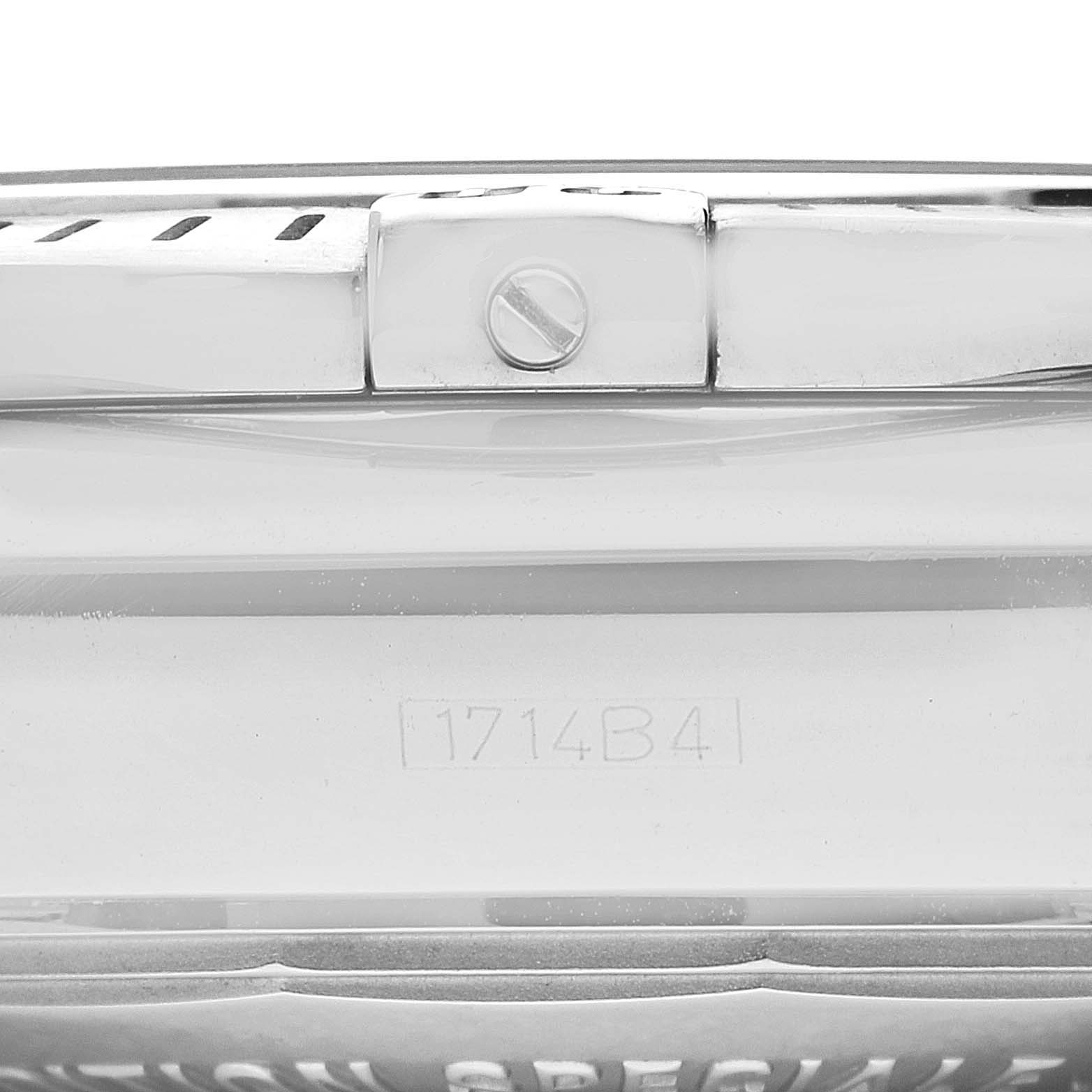 This is a close-up of the side and back of a Breitling Chronomat AB0115 Men's Stainless Steel Silver Dial AB0115 Men's Stainless Steel Silver Dial watch, showing a screw and serial number.
