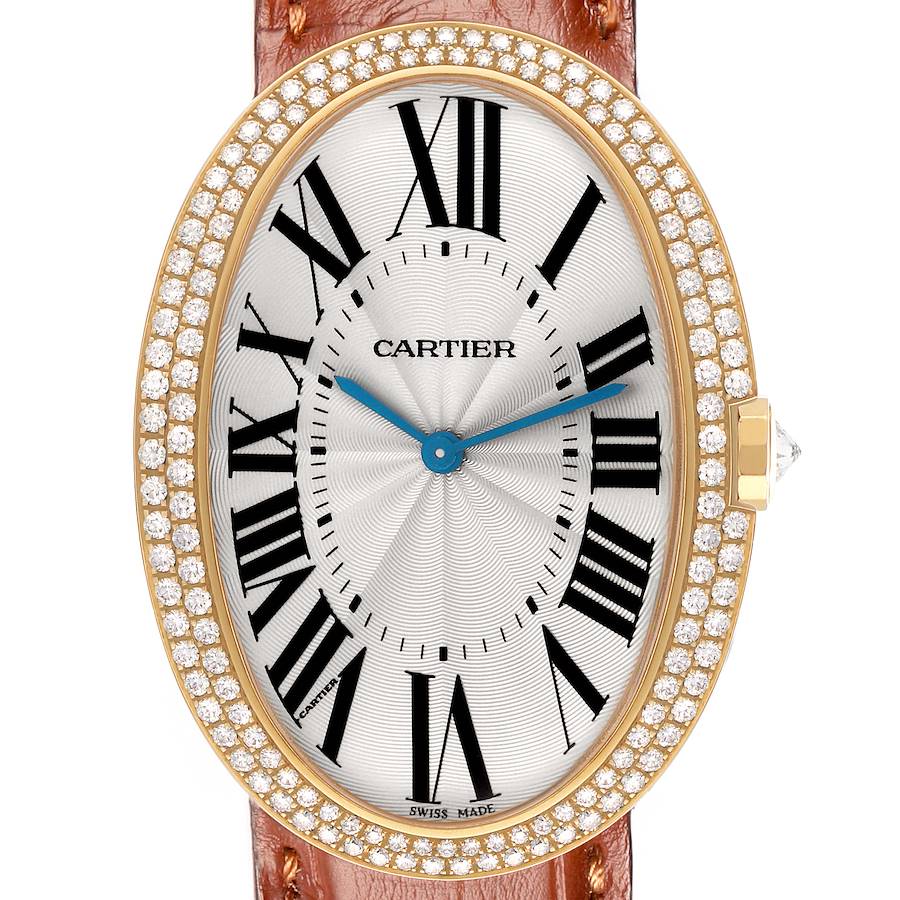 The Cartier Baignoire WB520005 Women's Yellow Gold Silver Dial watch is shown from a top view, highlighting its oval face, Roman numerals, diamond bezel, and brown strap.