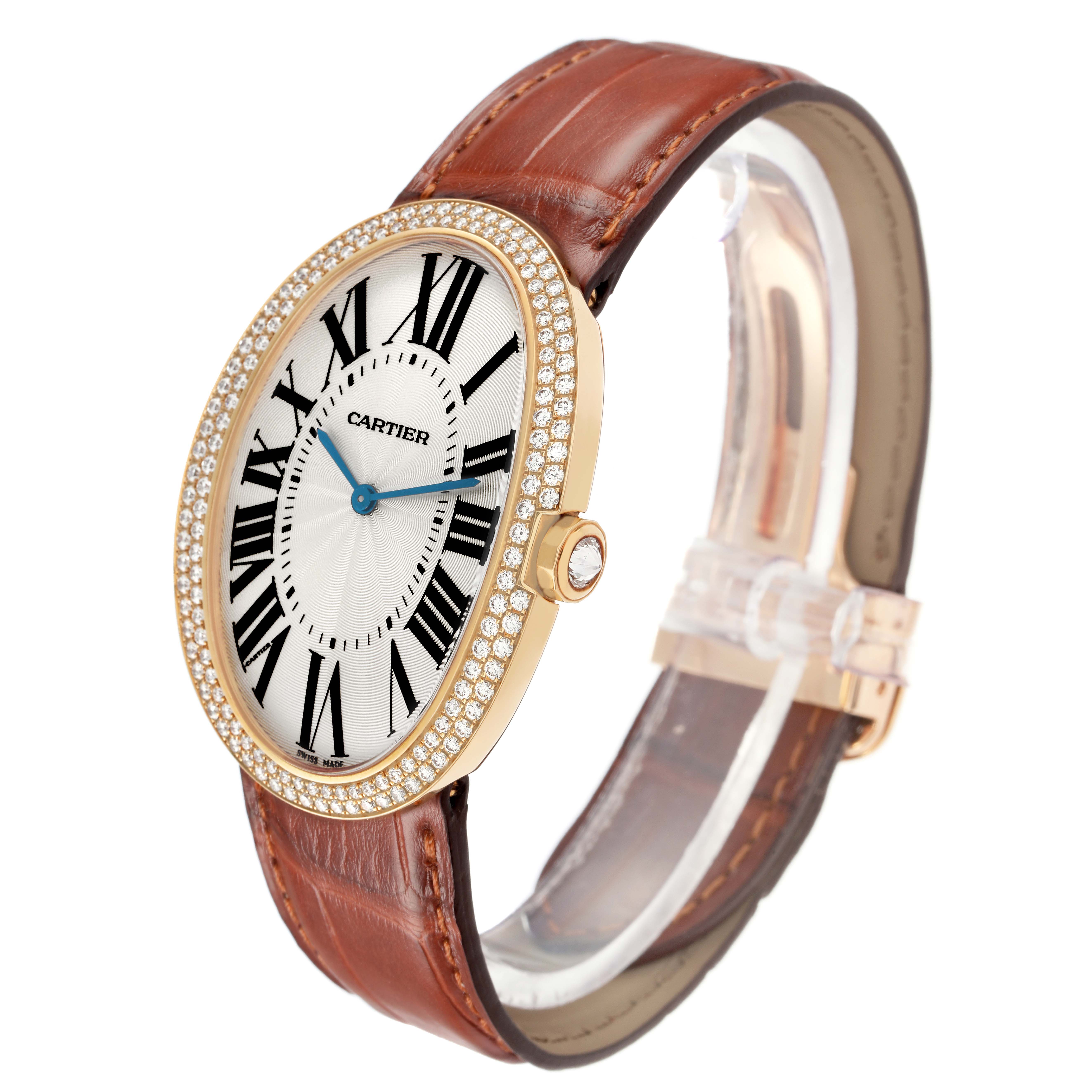 The Cartier Baignoire WB520005 Women
s Yellow Gold Silver Dial watch is viewed from a side angle, showing its oval face, diamond-set bezel, and brown leather strap.