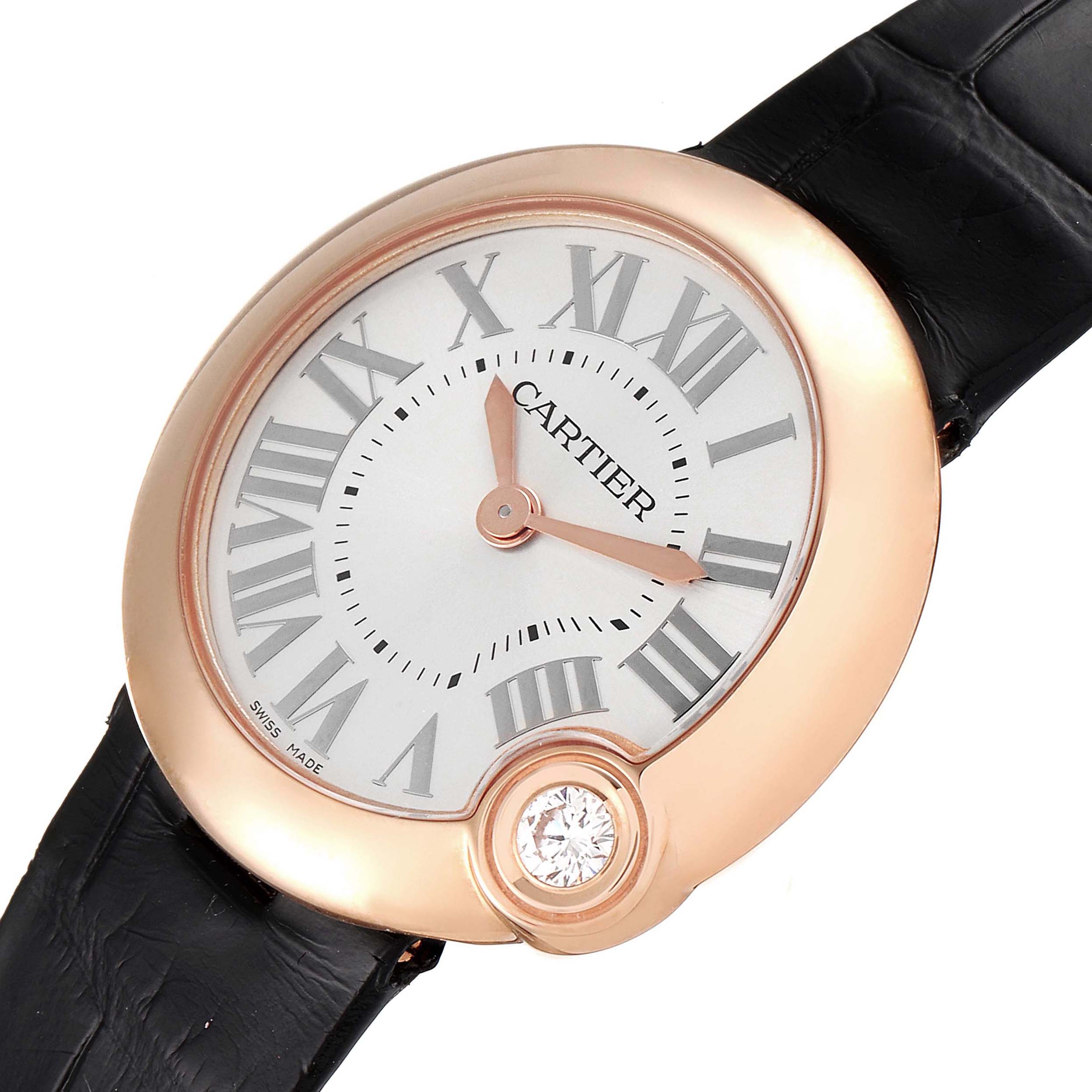 The image shows a close-up of the Cartier Ballon Bleu watch face with Roman numerals and a black leather strap at an angled view.