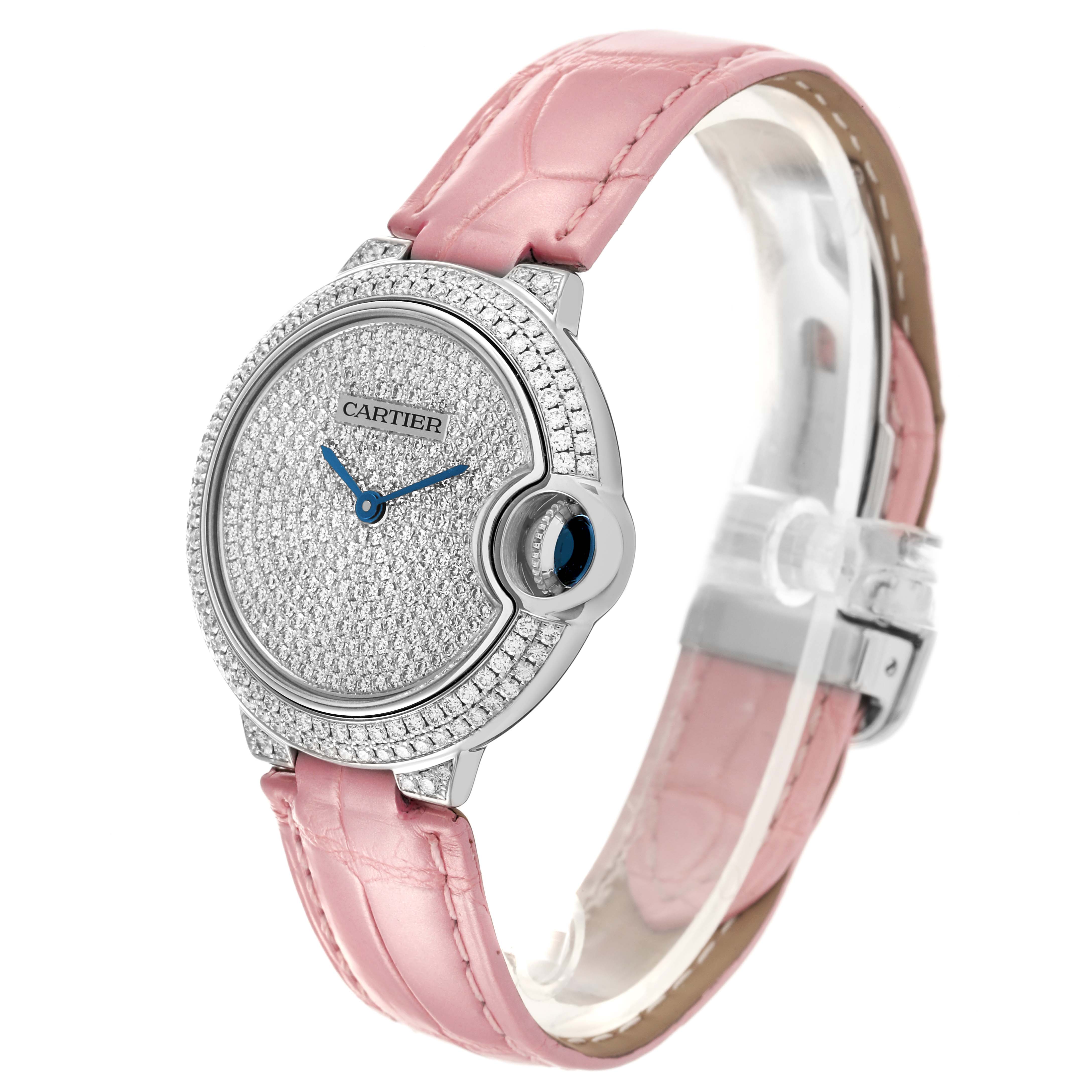The Cartier Ballon Bleu WE902047 Women's White Gold Silver Dial WE902047 Women's White Gold Silver Dial watch is shown at an angled side view, highlighting its pink strap and diamond-studded face.