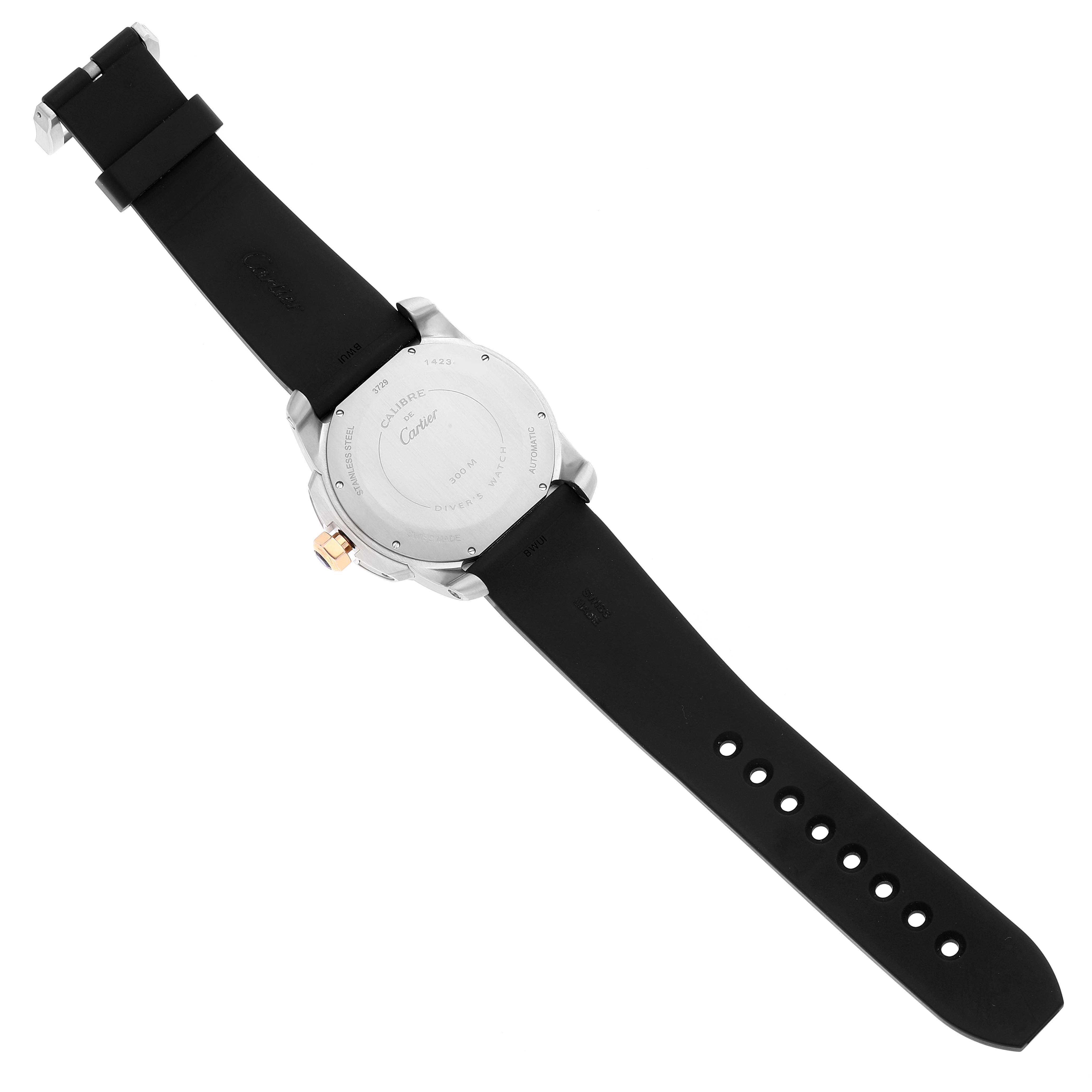 The image shows the back view of a Calibre de Cartier watch by Cartier, displaying the case back and black rubber strap.