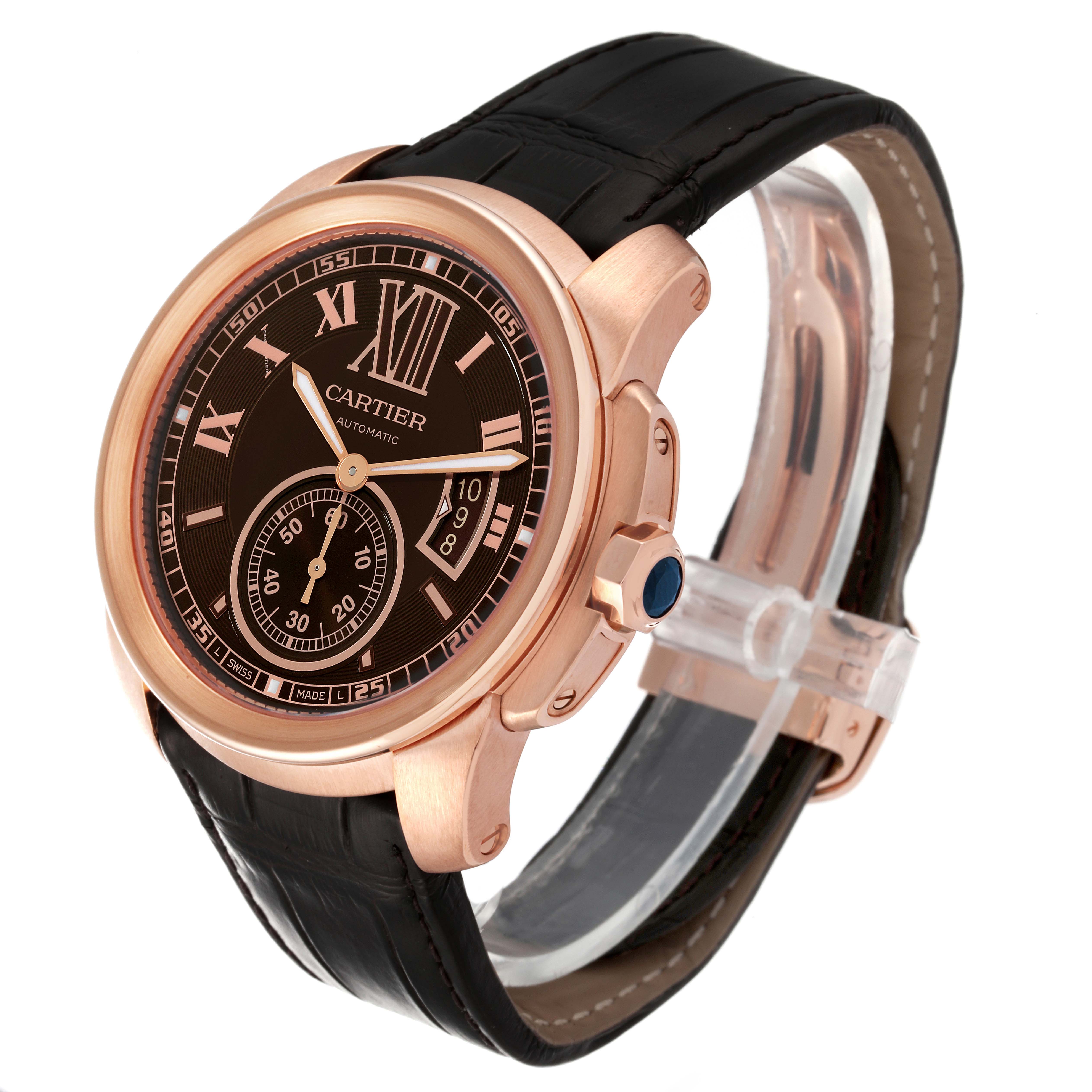 The Calibre de Cartier watch by Cartier is shown from a three-quarter angle, highlighting the face, bezel, crown, and leather strap.