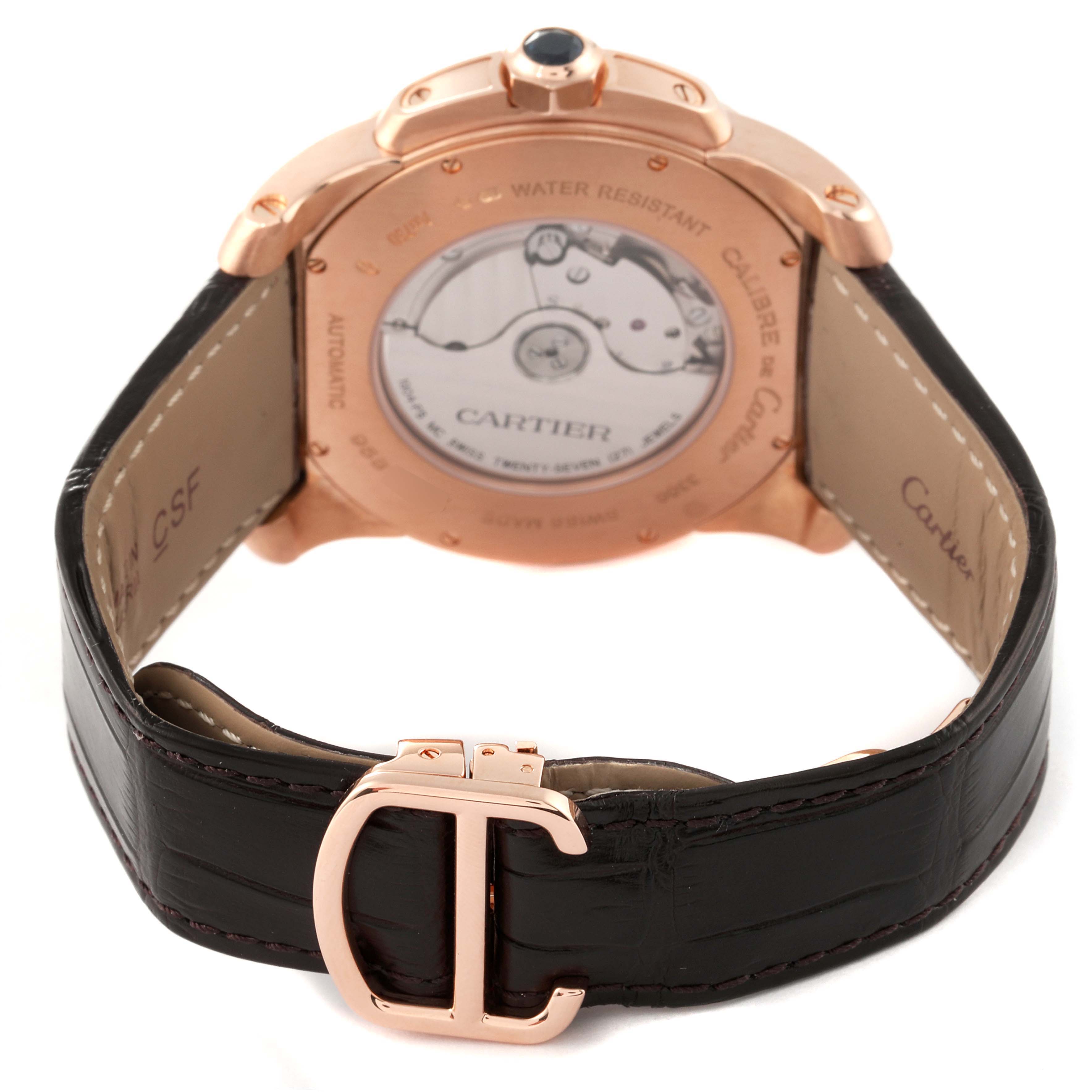 The image shows the rear view, clasp, and strap of the Calibre de Cartier model by Cartier.
