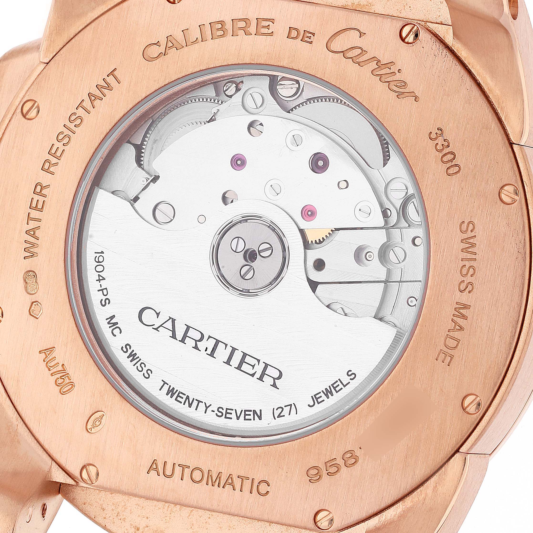 The image shows the back of the Calibre de Cartier watch, highlighting its automatic movement and detailed engravings.