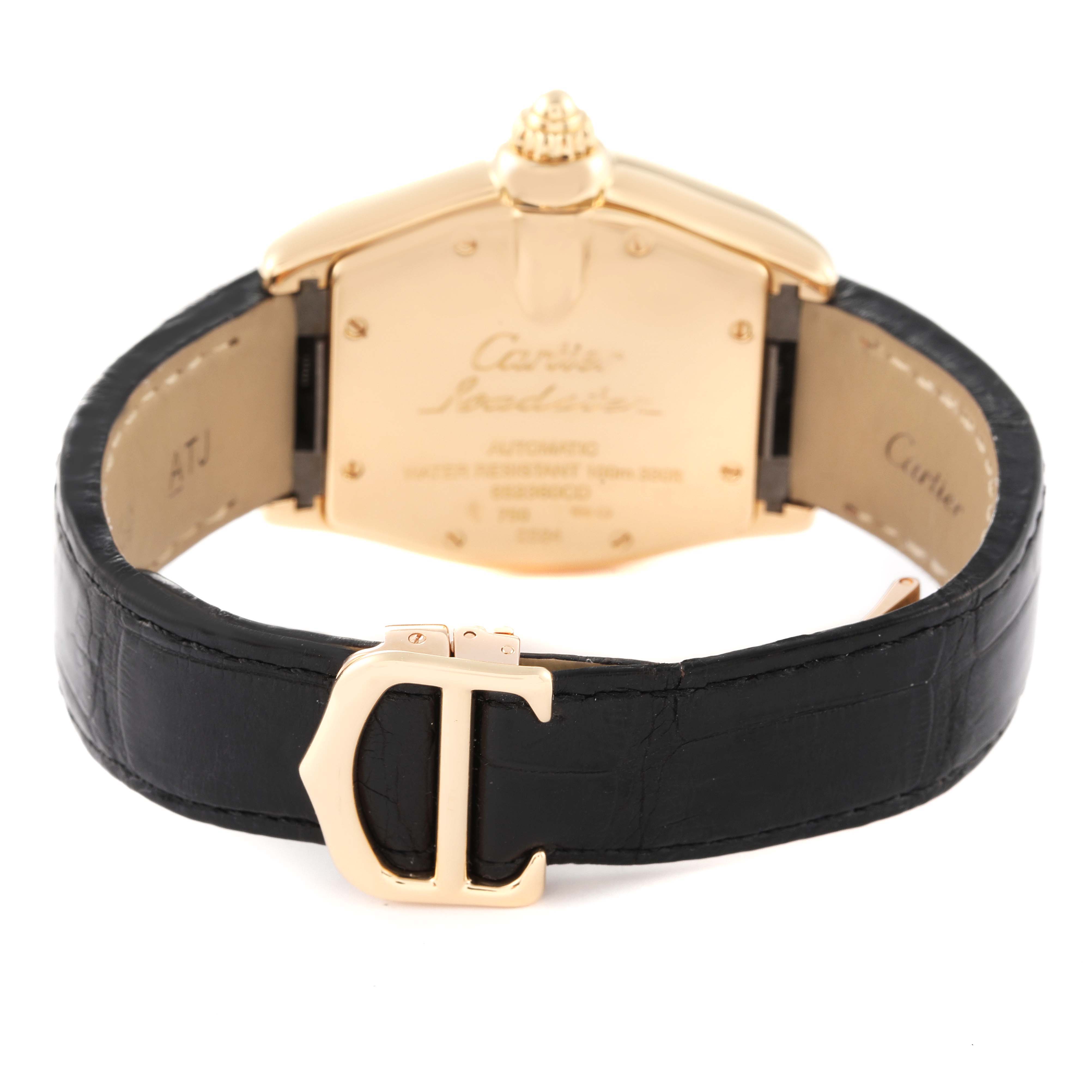 The image shows the back and strap of a Cartier Roadster W62005V2 Men's Yellow Gold Silver Dial W62005V2 Men's Yellow Gold Silver Dial watch, featuring a black leather band and gold clasp.