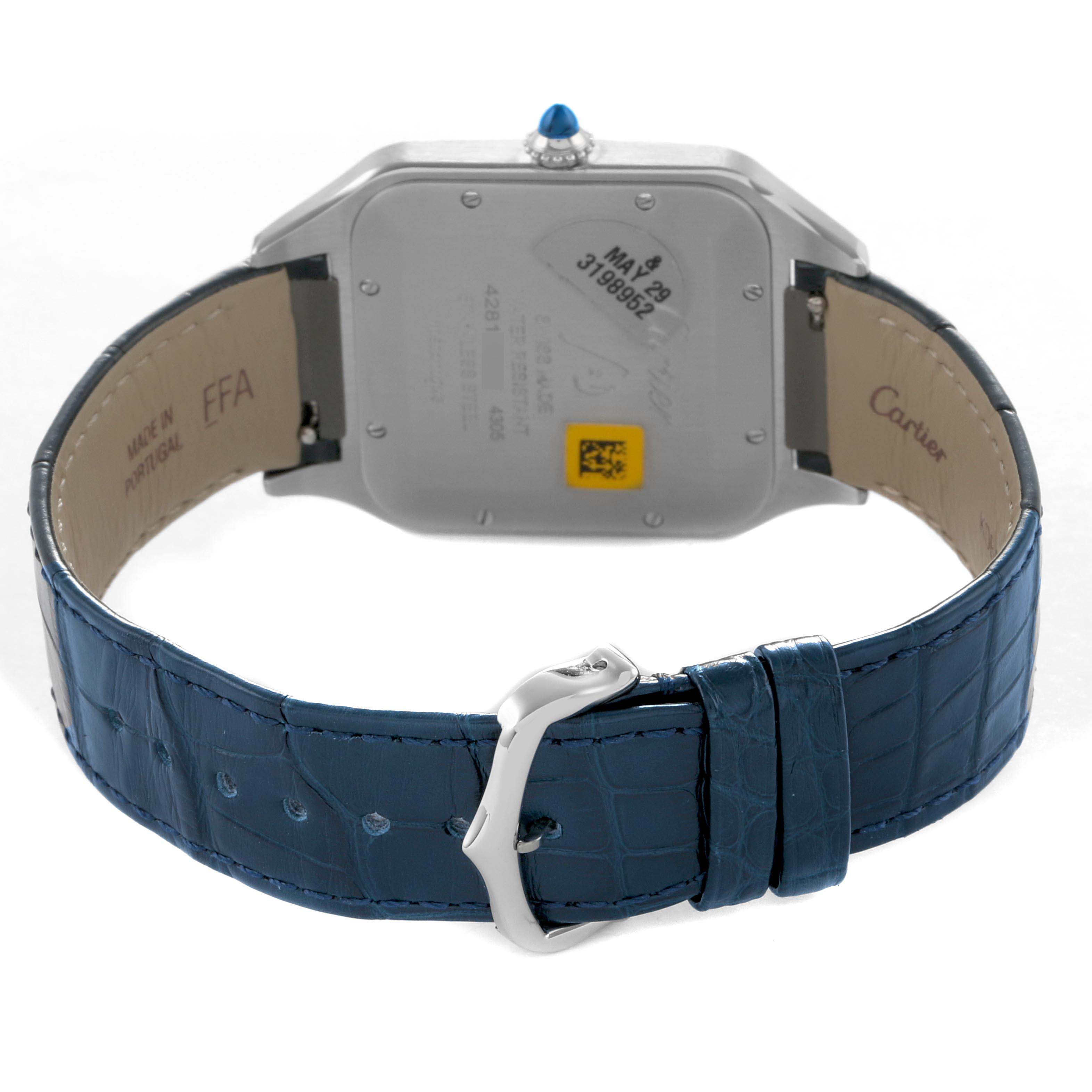 The image shows the back of the Cartier Santos Dumont WSSA0032 Men's Stainless Steel Silver Dial watch, featuring its case back, blue strap, and buckle.