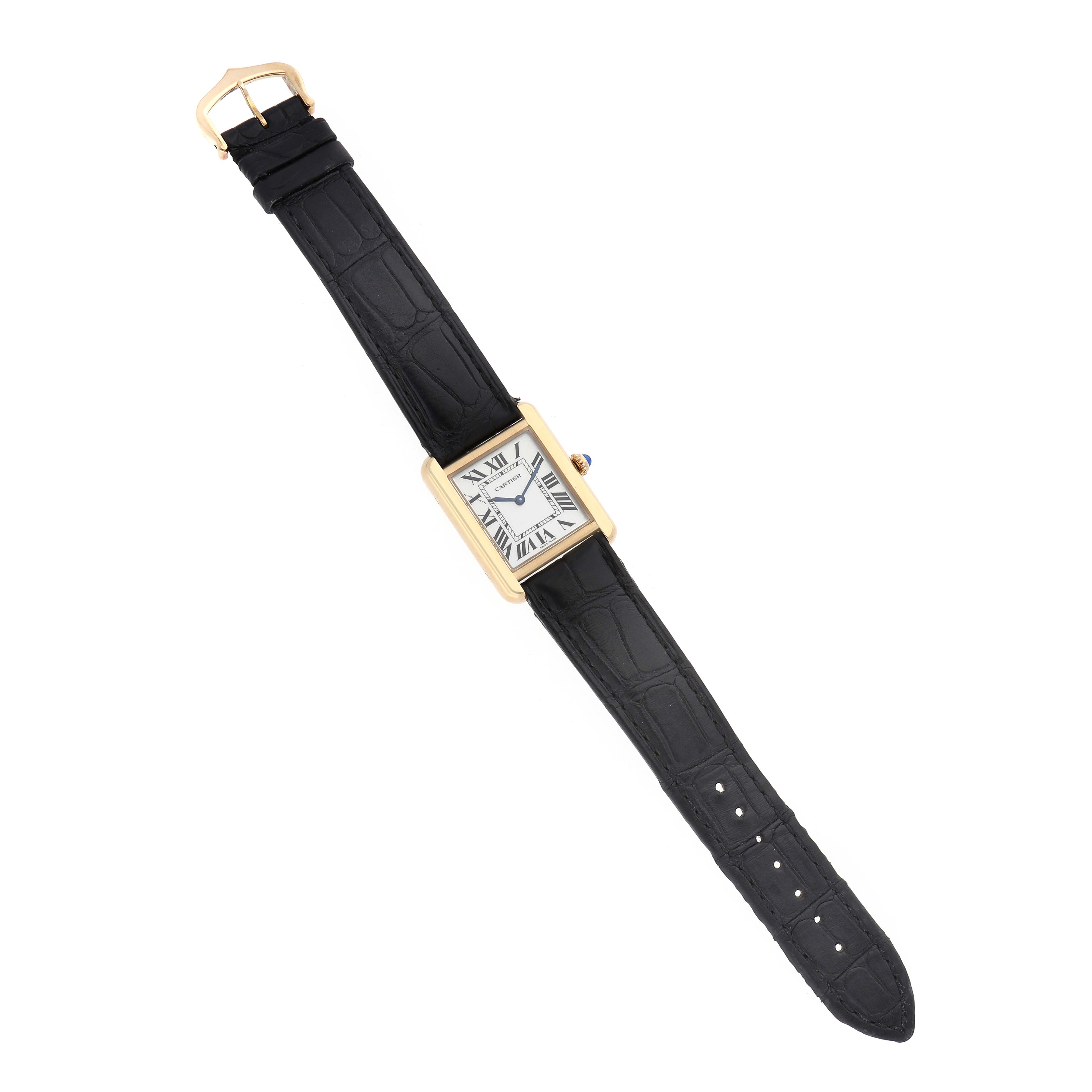 The Cartier Tank Solo W5200002 Men's Steel and Gold (two tone) White Dial watch is shown from a top-view angle, highlighting the rectangular face, sleek black strap, and buckle.