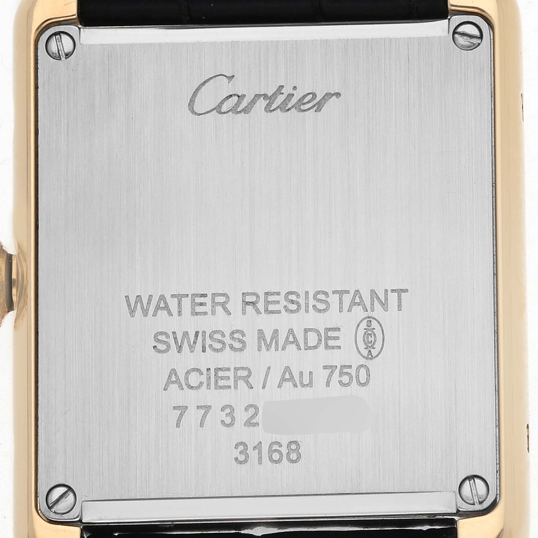The image shows the back case of the Cartier Tank Solo W5200002 Men's Steel and Gold (two tone) White Dial watch, highlighting inscriptions and screws.