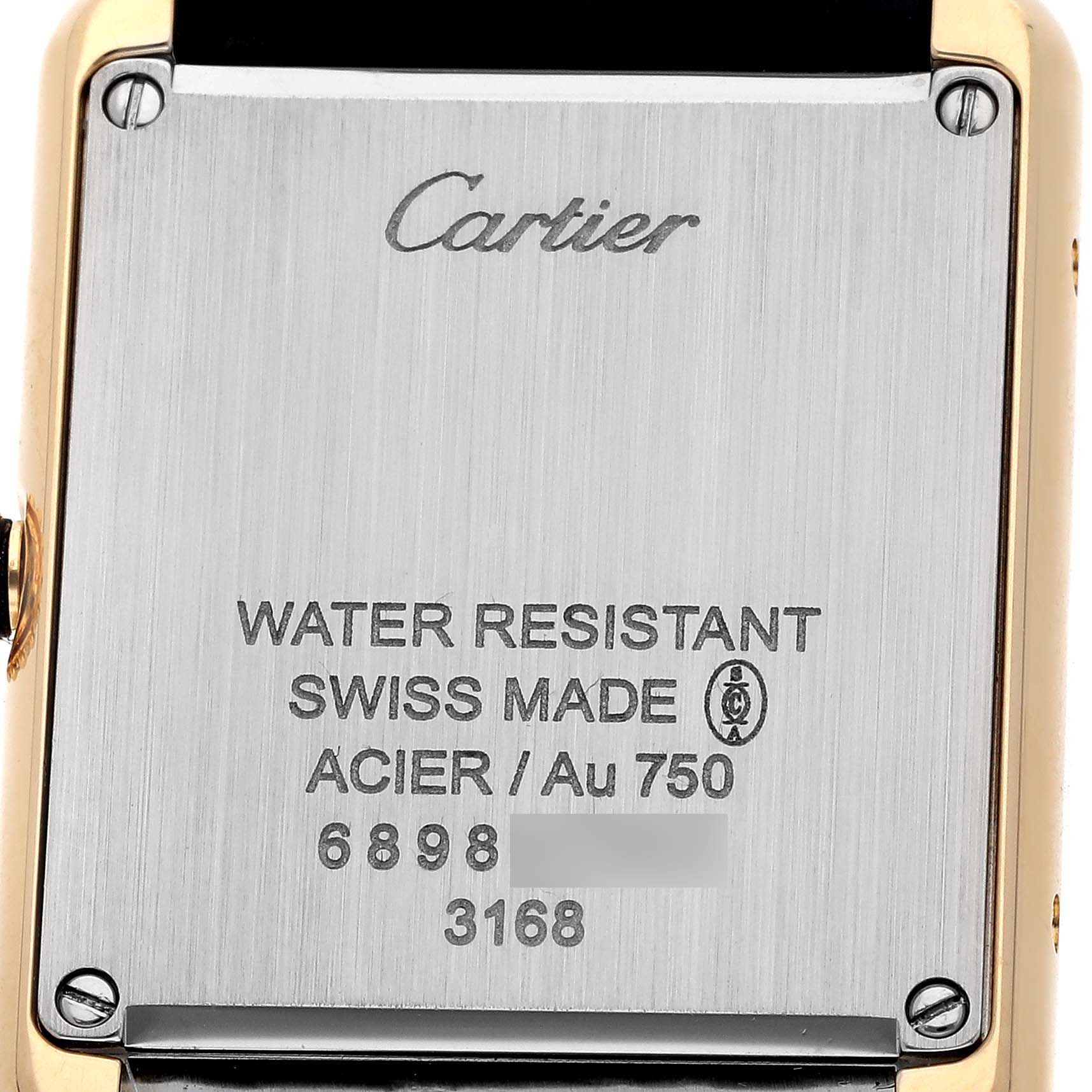 The image shows the back case of a Cartier Tank Solo W5200002 Women's Steel and Gold (two tone) Silver Dial watch, detailing its inscriptions and gold accents.