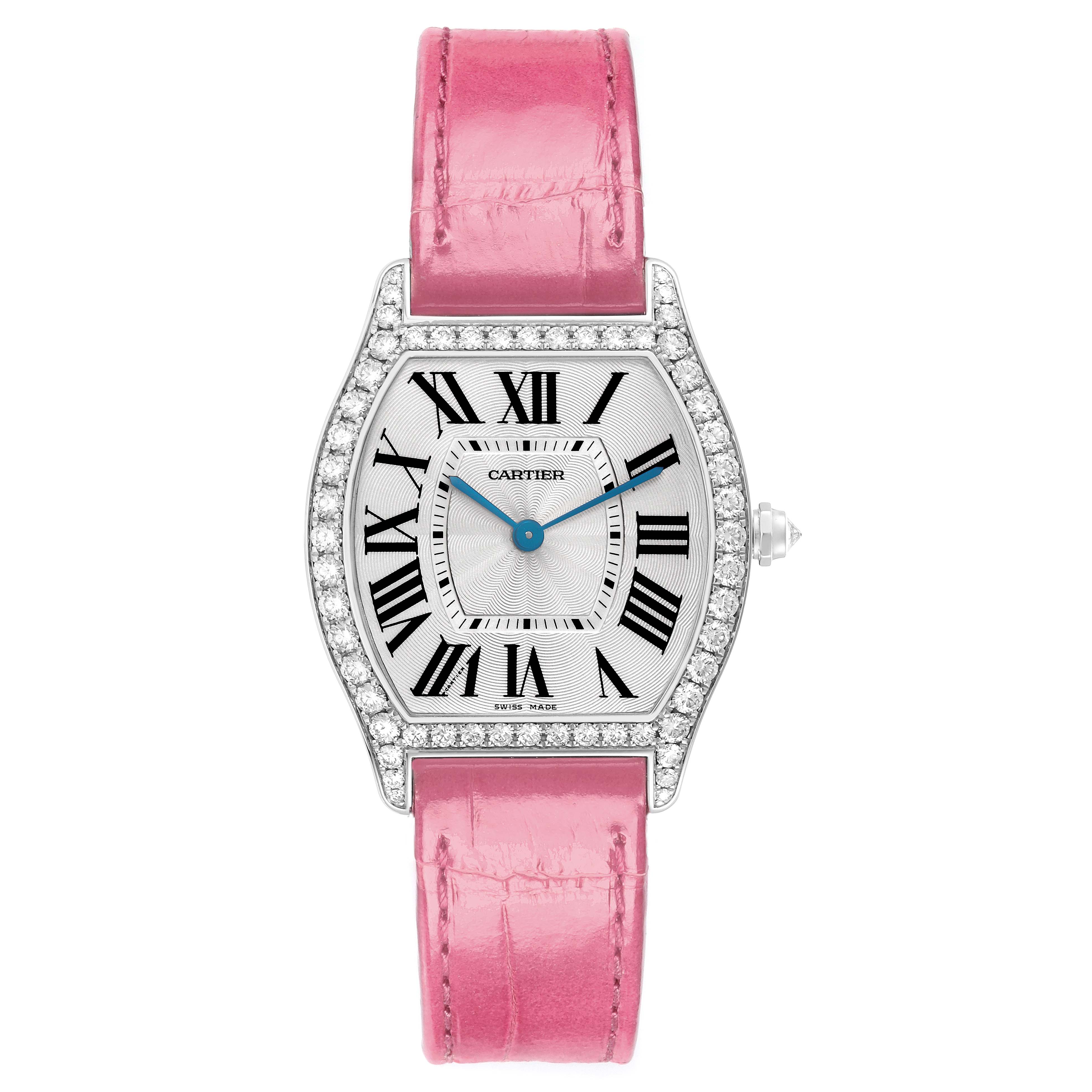 The Cartier Tortue model watch, number WA501009, features a front view showing a diamond-set bezel, Roman numeral dial, blue sword hands, and a pink leather strap.