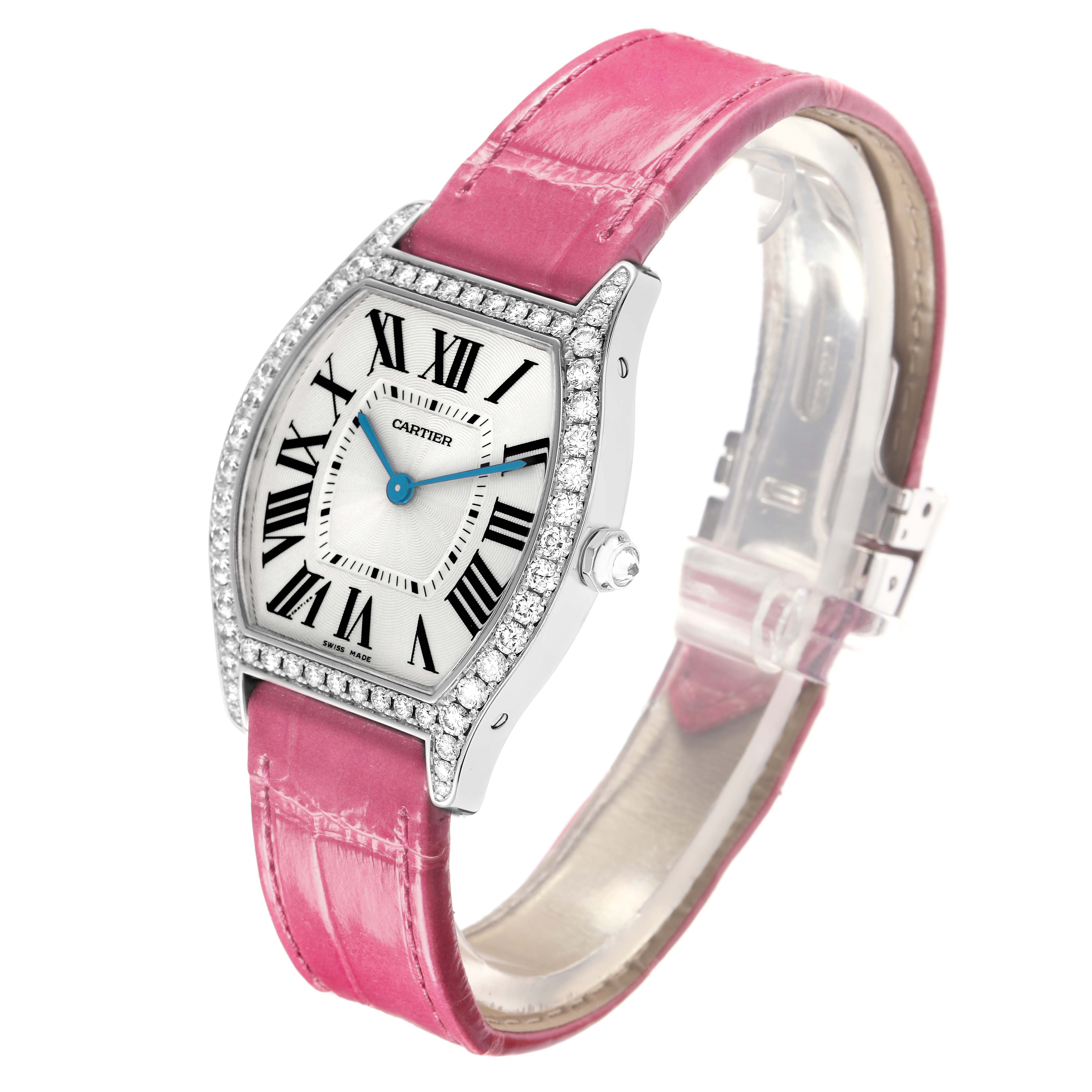 The Cartier Tortue model WA501009 men's watch is shown at an angled view displaying the dial, Roman numerals, pink strap, diamond-set bezel, and crown.
