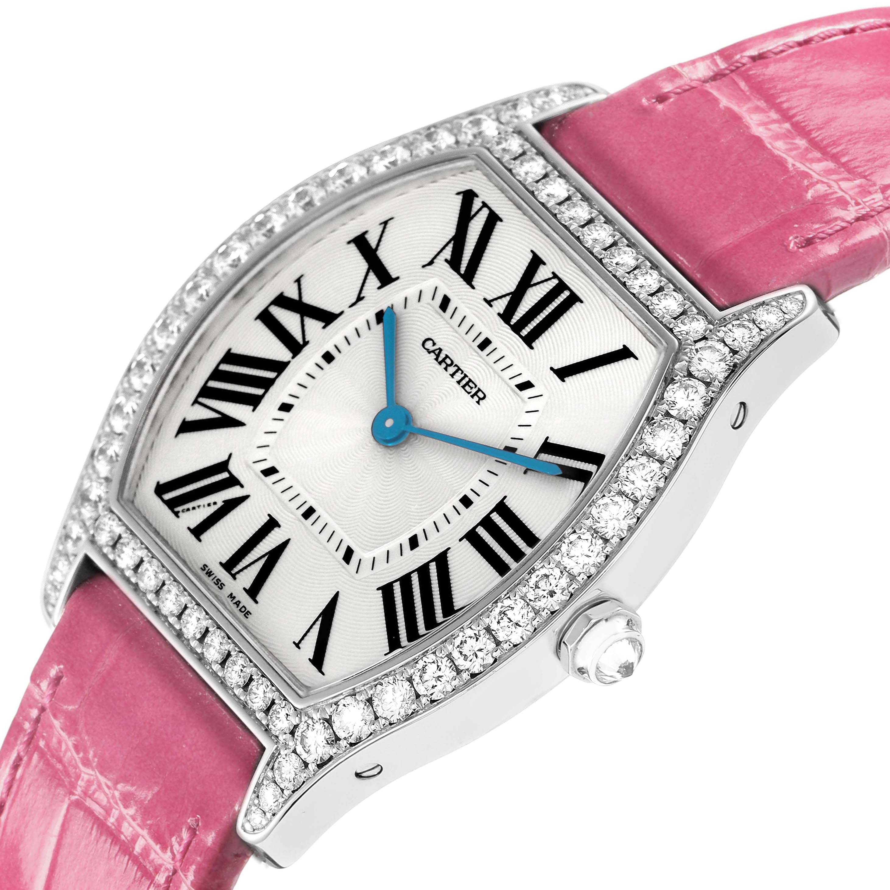 The Cartier Tortue model WA501009 is shown at an angled view, highlighting the diamond-encrusted bezel, white dial with Roman numerals, and pink strap.
