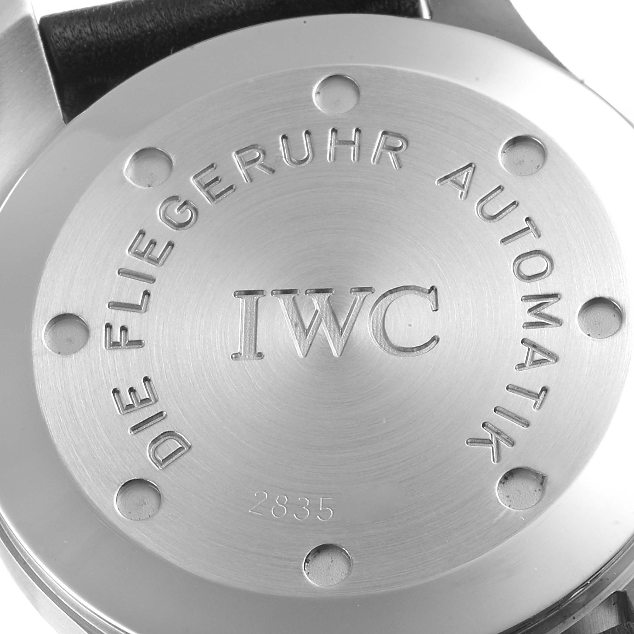 The image shows the back case of an IWC Pilot IW325301 Men's Stainless Steel Black Dial IW325301 Men's Stainless Steel Black Dial model watch, displaying the brand name and model details.