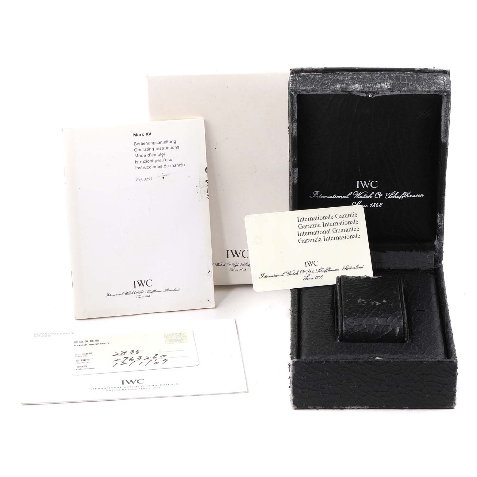 The image shows IWC Pilot IW325301 Men's Stainless Steel Black Dial IW325301 Men's Stainless Steel Black Dial watch accessories including a black box, manuals, and international guarantee card.