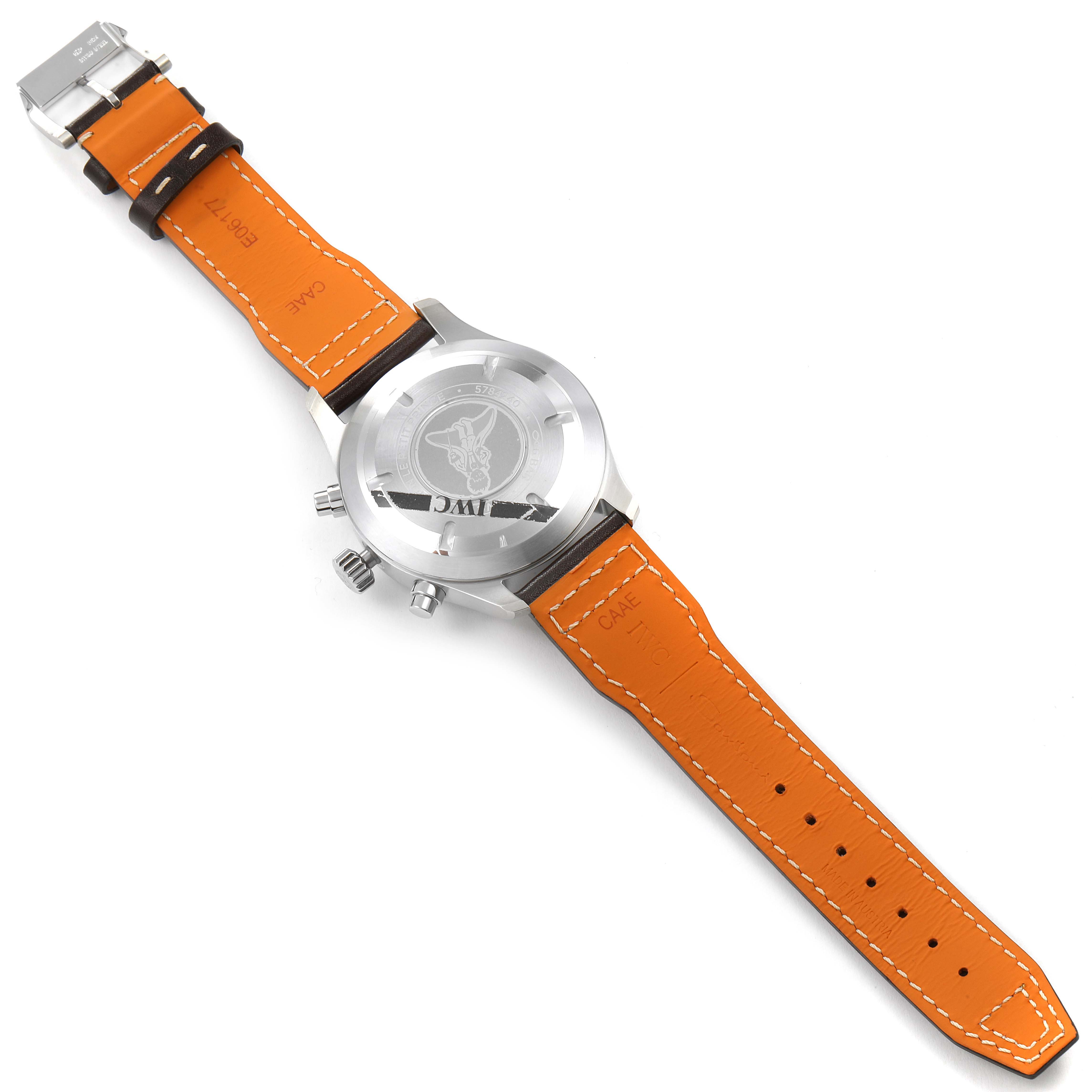 The image shows the back and strap of the IWC Pilot IW377714 Men's Stainless Steel Blue Dial IW377714 Men's Stainless Steel Blue Dial watch, featuring an orange leather band and a detailed case back engraving.