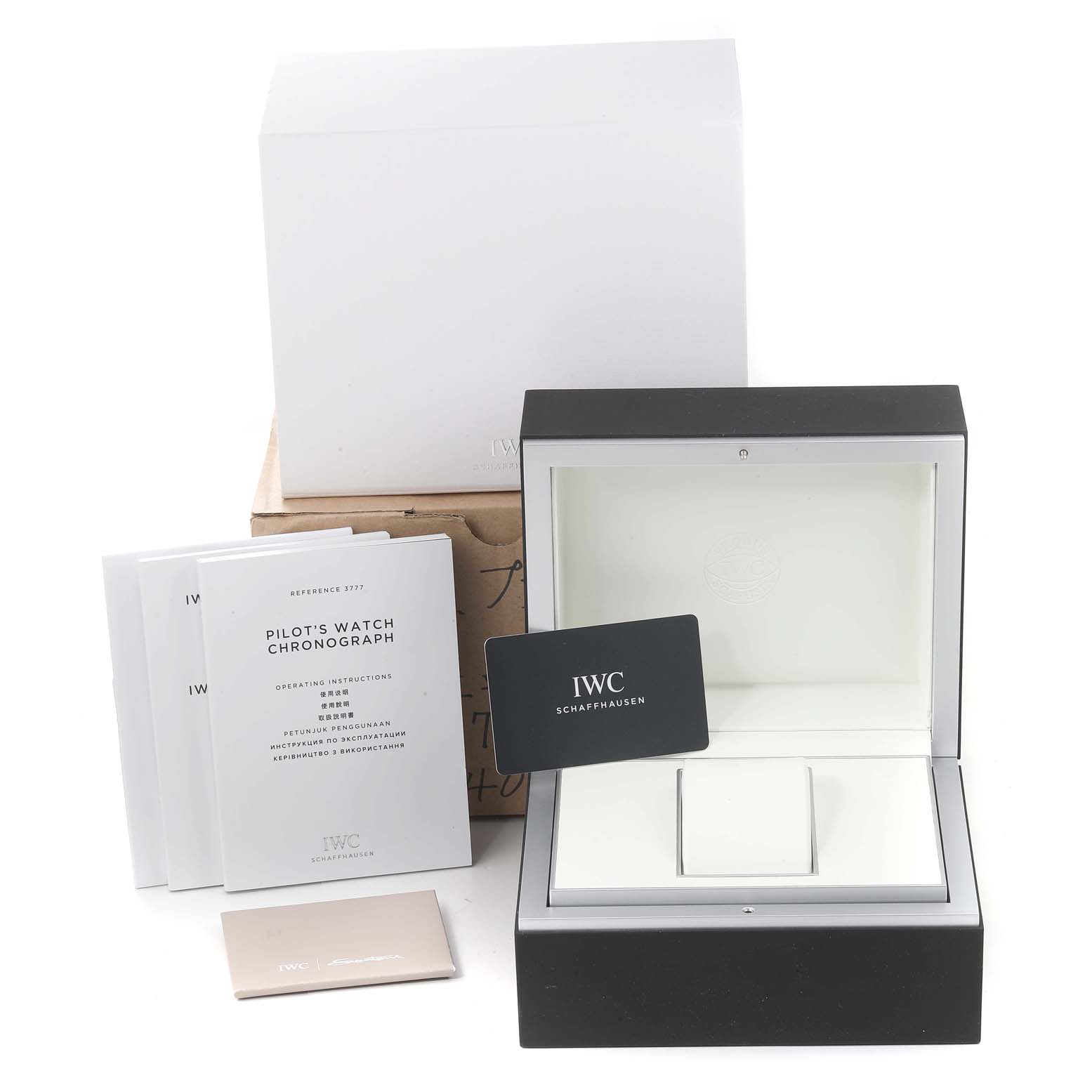 The image shows an IWC Pilot IW377714 Men's Stainless Steel Blue Dial IW377714 Men's Stainless Steel Blue Dial watch's box, instruction booklets, warranty card, and packaging.