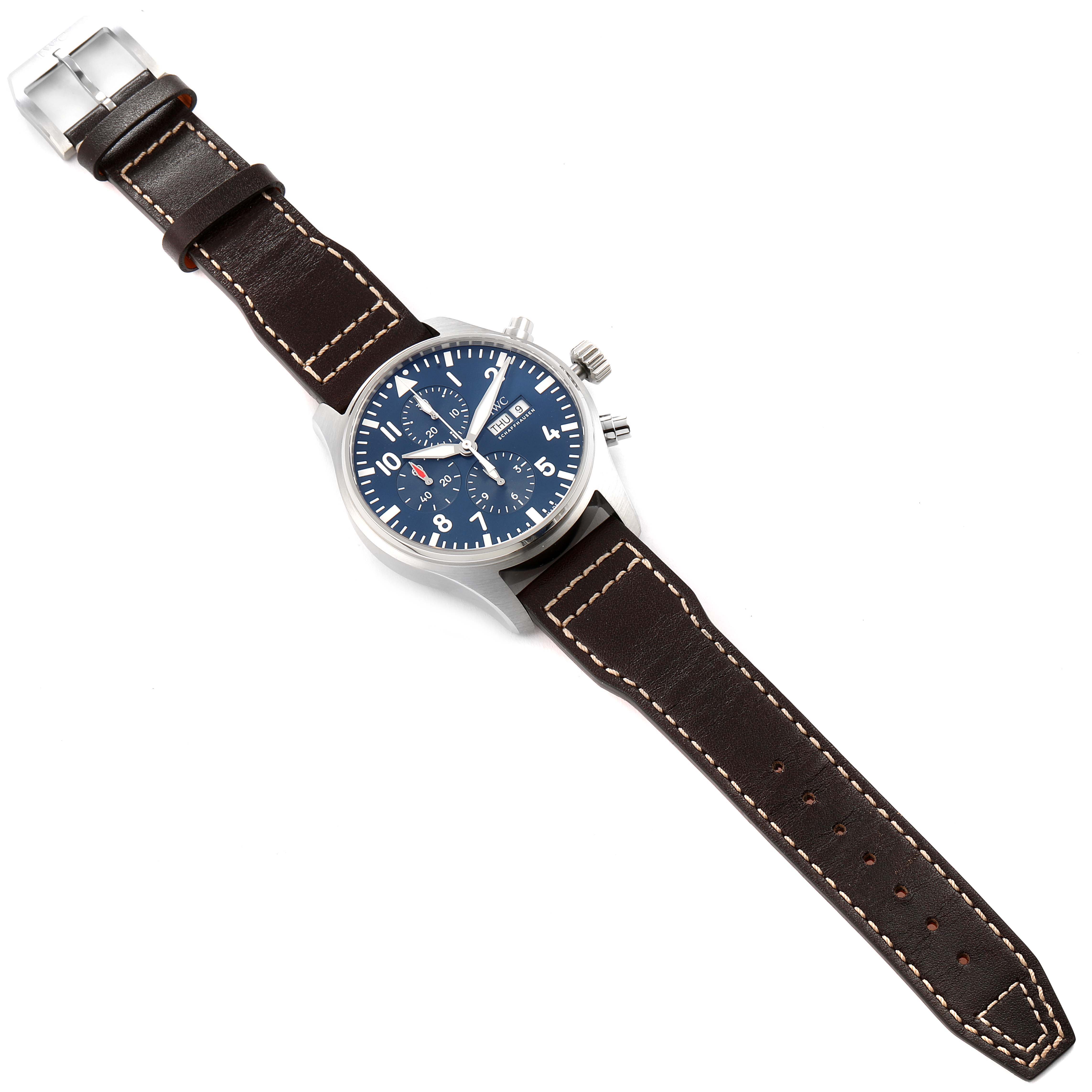 The IWC Pilot IW377714 Men's Stainless Steel Blue Dial IW377714 Men's Stainless Steel Blue Dial model watch is shown fully extended with a brown leather strap, blue dial, and silver case at a slight angle from above.