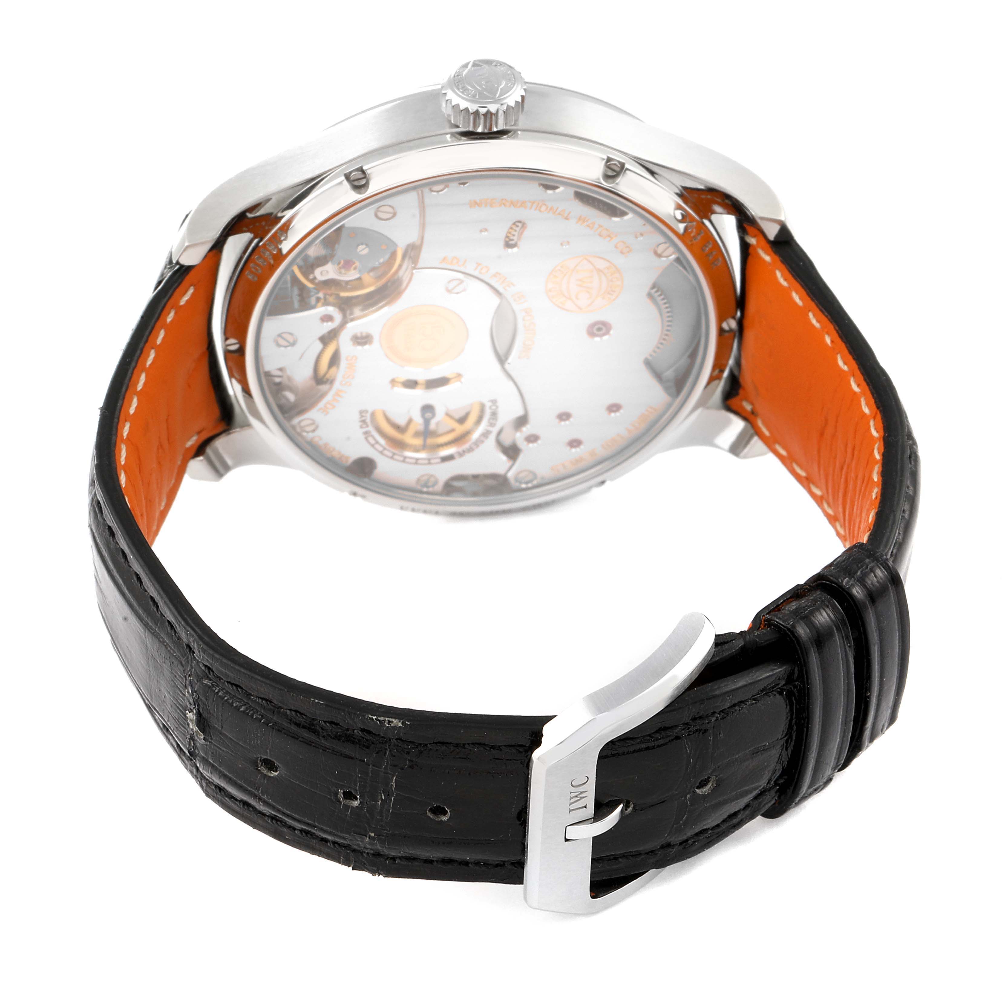 The image shows the back view of the IWC Portuguese IW510212 Men's Stainless Steel White Dial IW510212 Men's Stainless Steel White Dial watch, focusing on the transparent case back and black strap with an orange lining.