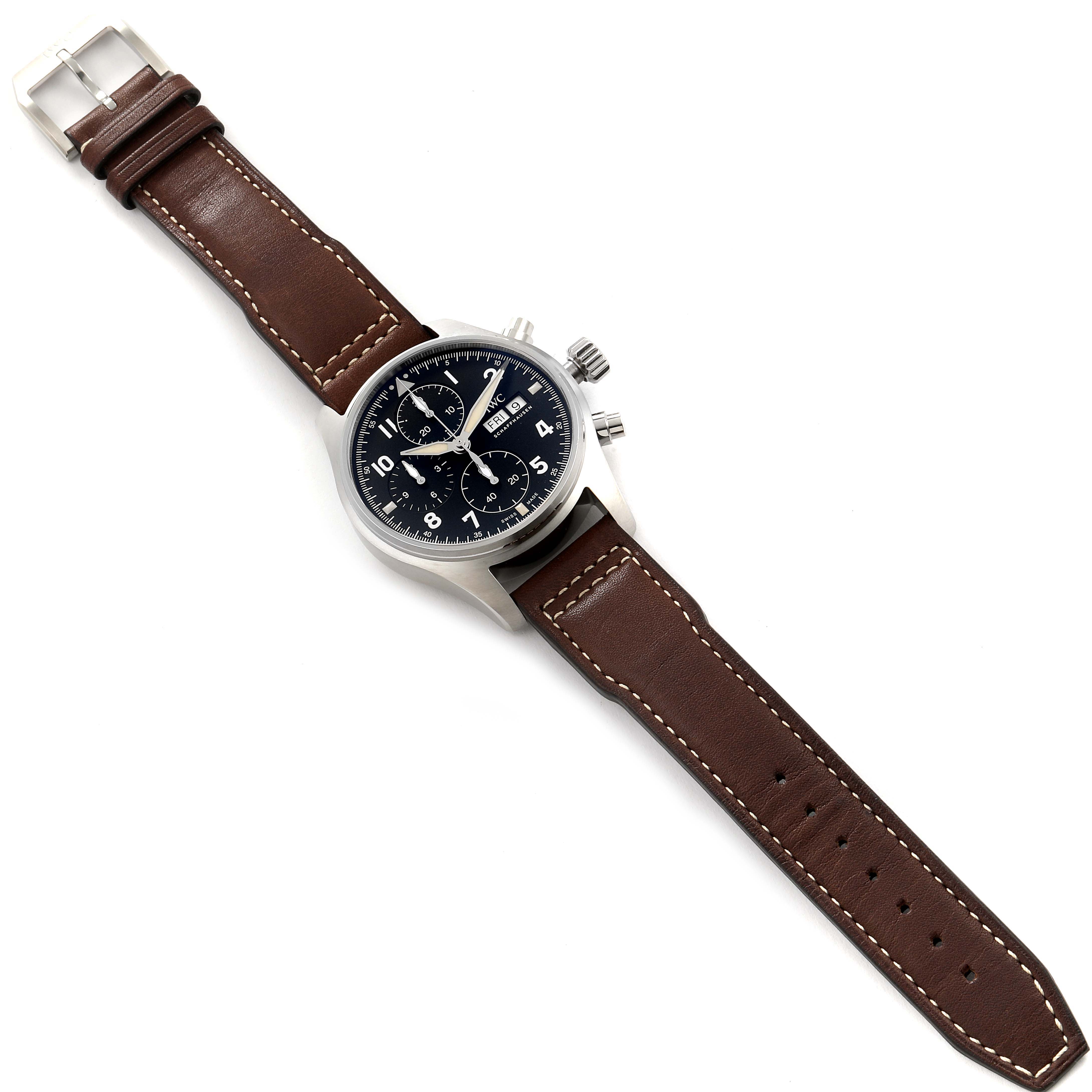The image shows the IWC Pilot IW387903 Men
s Stainless Steel Black Dial IW387903 Men
s Stainless Steel Black Dial model watch, captured from a top-down angle, displaying the face, bezel, crown, pushers, and brown leather strap.
