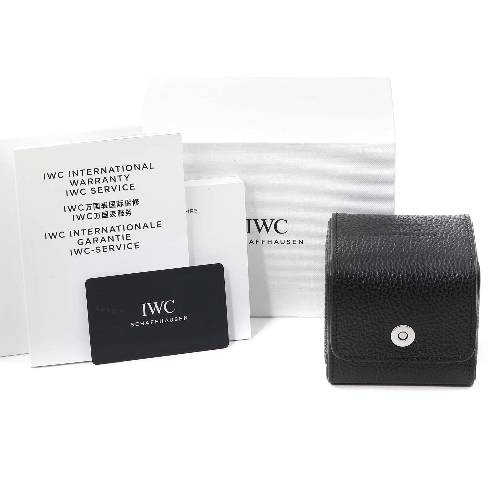 The image shows the IWC Pilot IW387903 Men
s Stainless Steel Black Dial IW387903 Men
s Stainless Steel Black Dial model
s packaging, warranty cards, manuals, a black cardholder, and a black textured travel case.