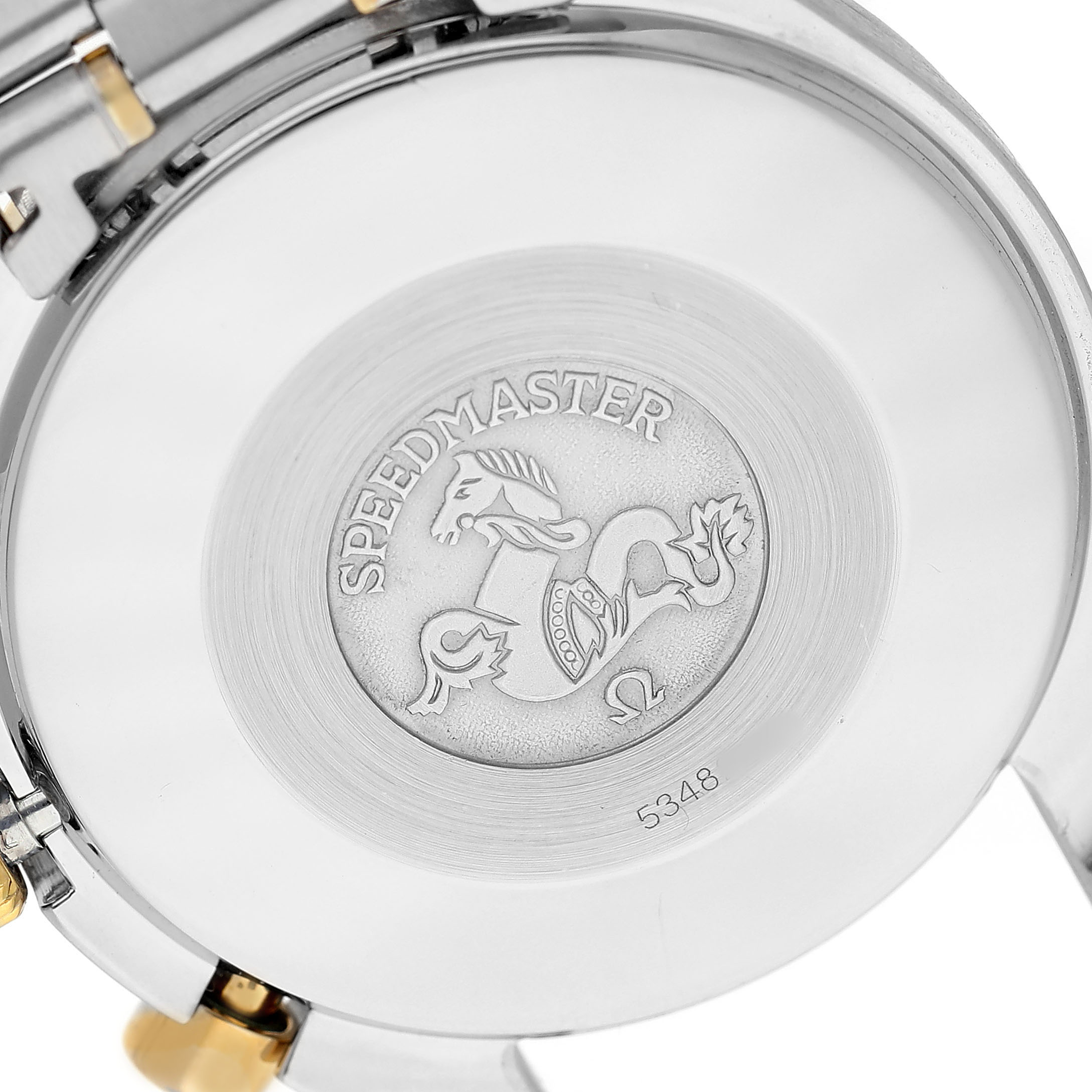 The image shows the back of an Omega Speedmaster 3310.10.00 Men's Steel and Gold (two tone) Champagne Dial watch, featuring its engraved case back design.