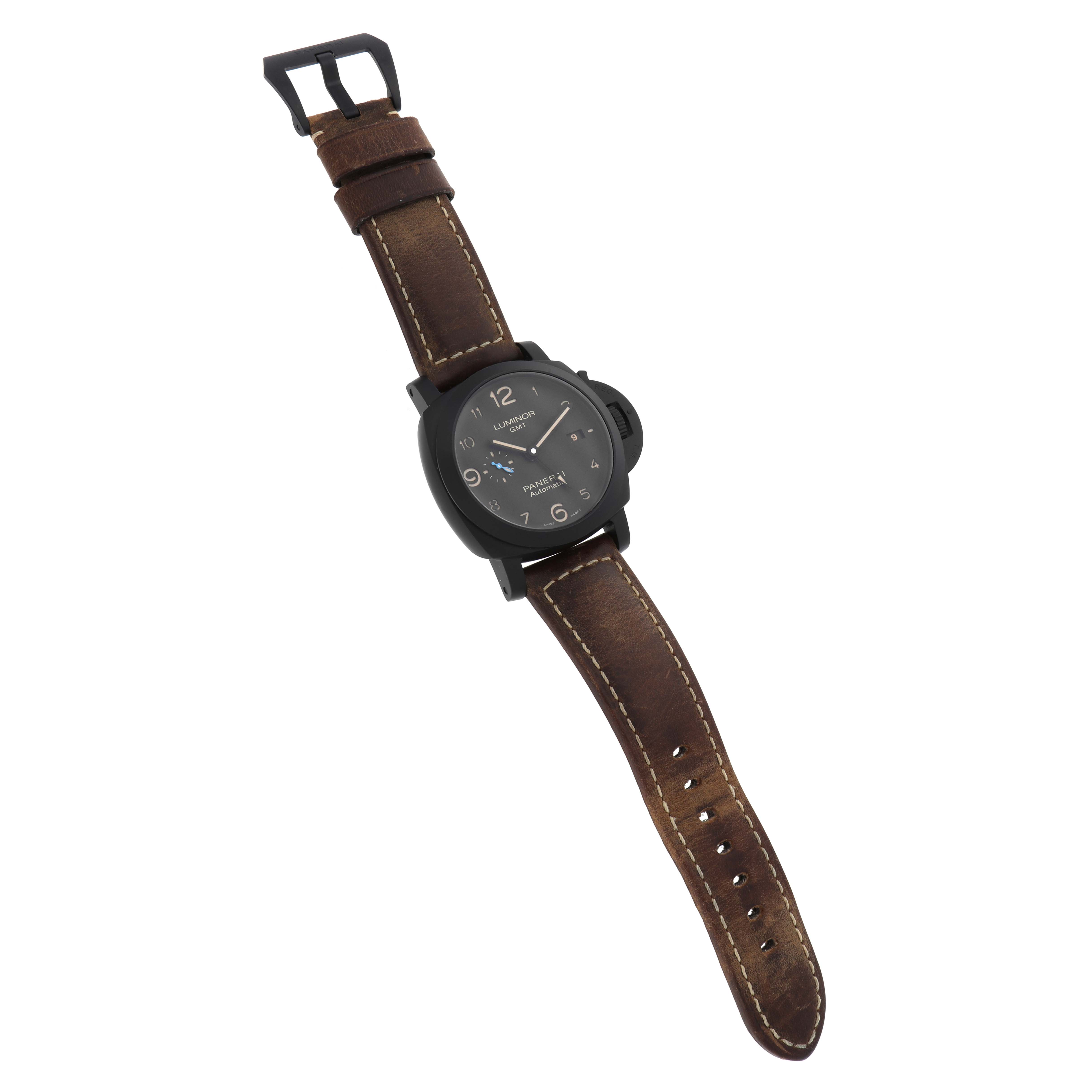 The Luminor model by Panerai is shown from a slight top-down angle, displaying the face, crown guard, and brown leather strap.