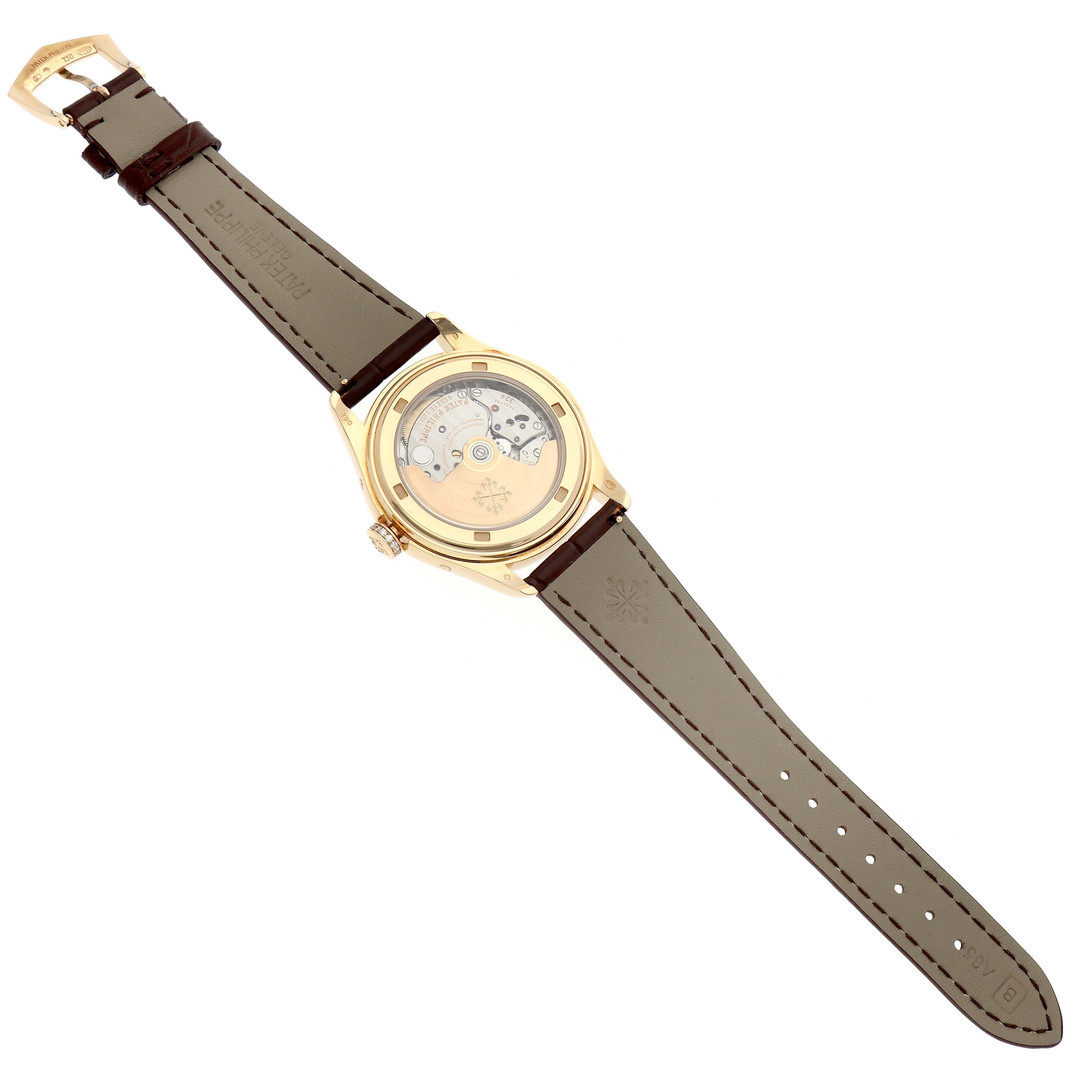 The Patek Philippe Complications 4936J - 001 Men's Yellow Gold Mother of Pearl Dial watch is shown from the back, displaying the movement and leather strap.