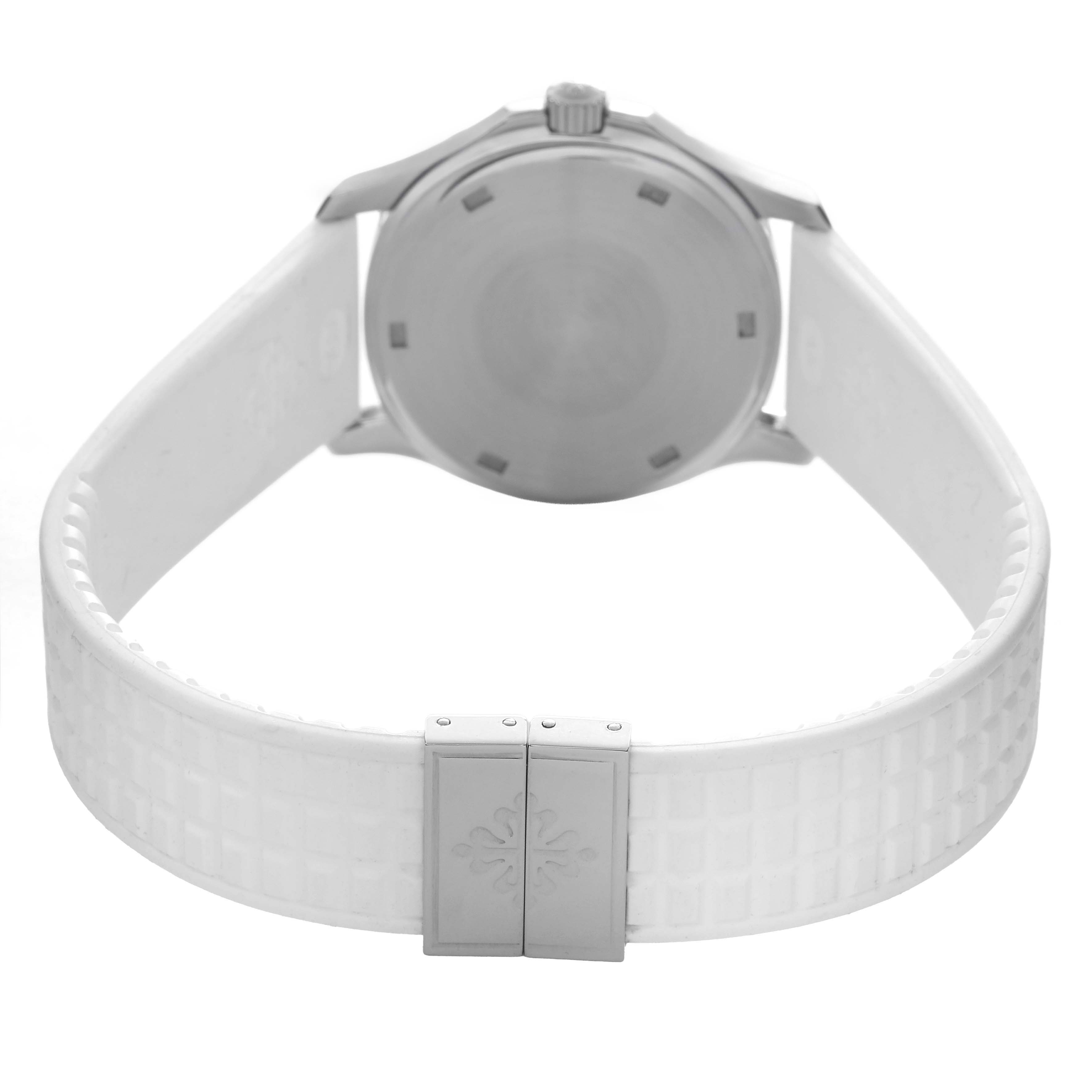 The image shows the back of the Patek Philippe Aquanaut 5267A Women's Stainless Steel White Dial watch, focusing on the case back and white strap with a clasp.
