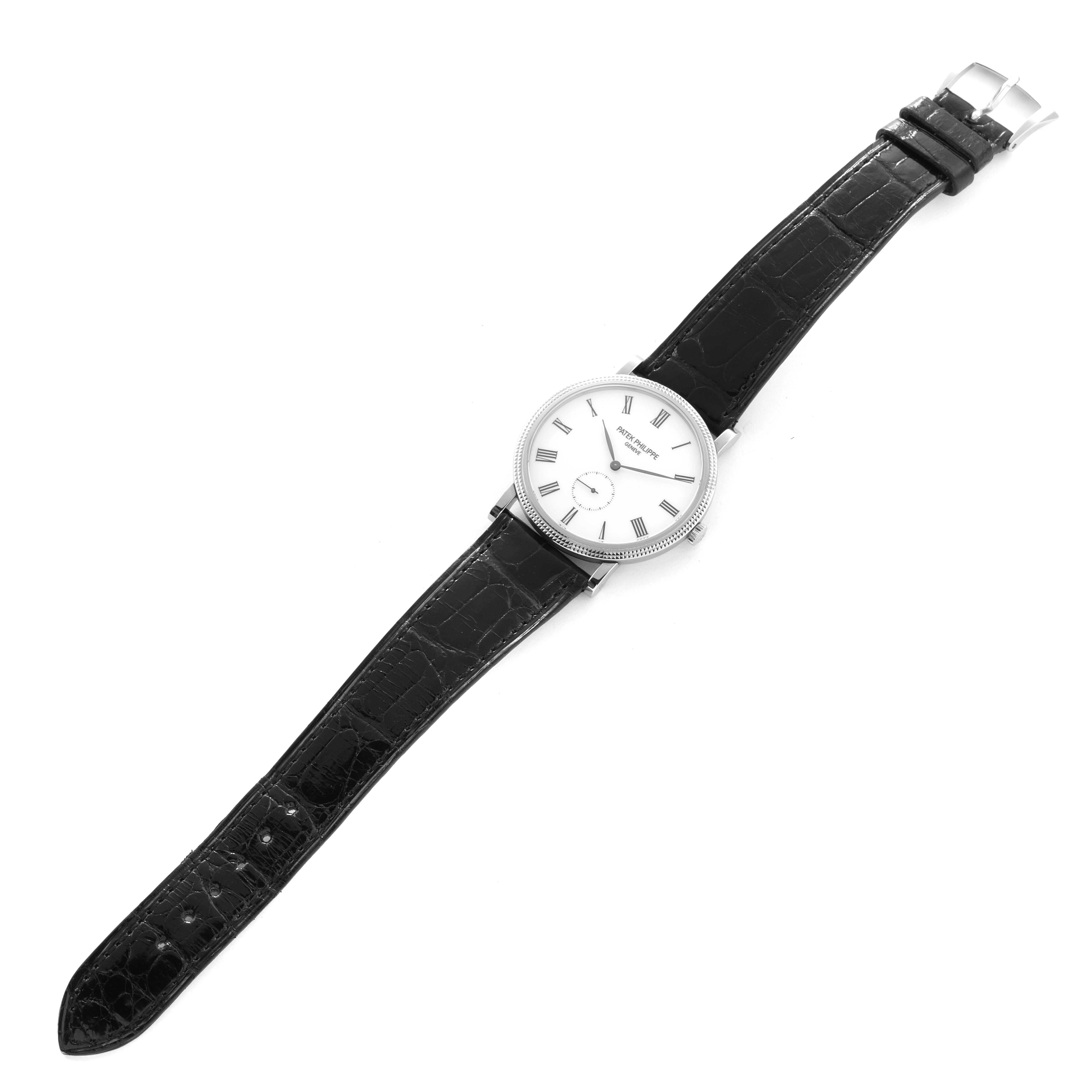 The Patek Philippe Calatrava 5119G Men
s White Gold White Dial watch is shown from a top-down angle, displaying the face, bezel, and full leather strap.