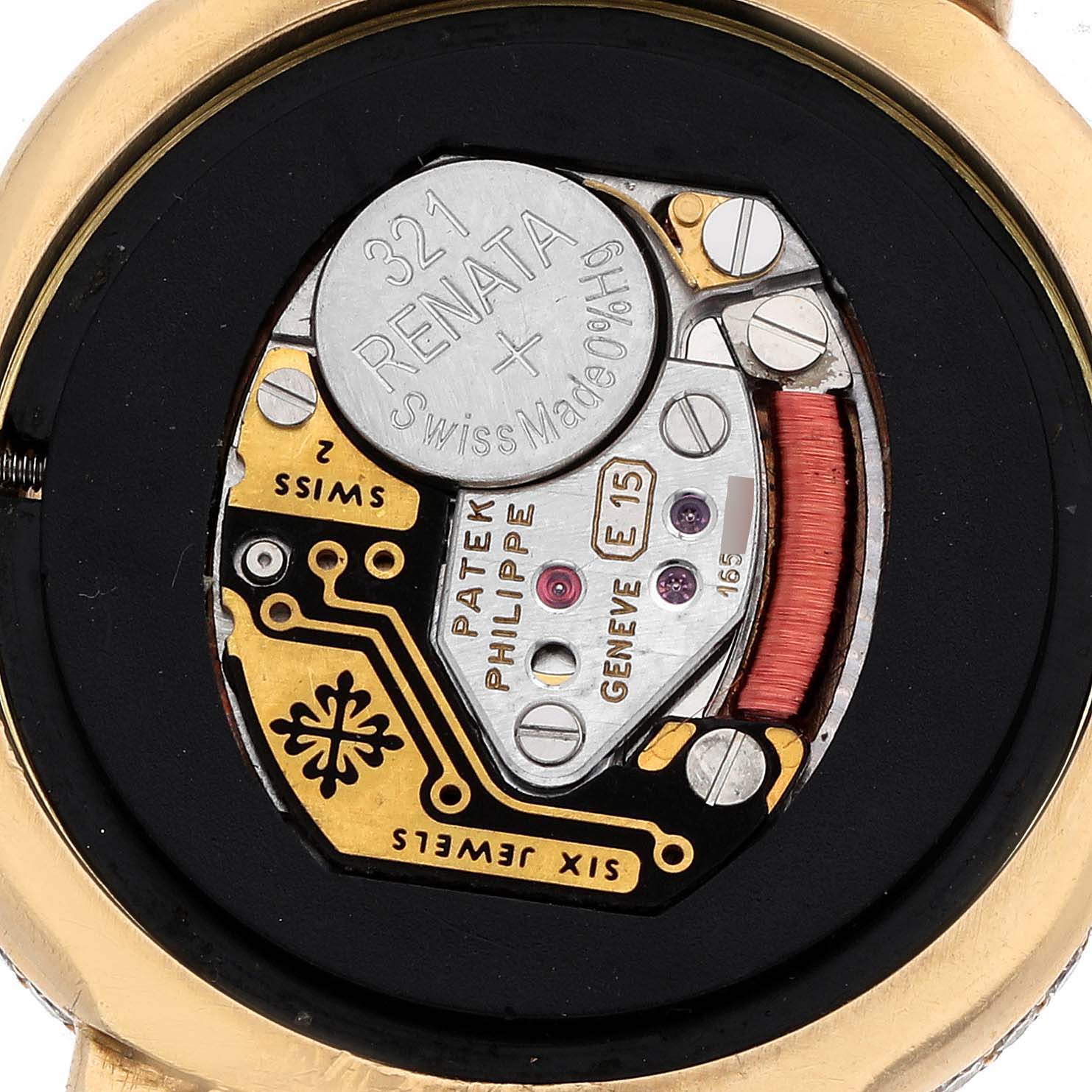 The image shows the back internal view of a Patek Philippe Golden Ellipse 3848 Women's Yellow Gold Mother of Pearl Dial watch, highlighting its battery and movement components.