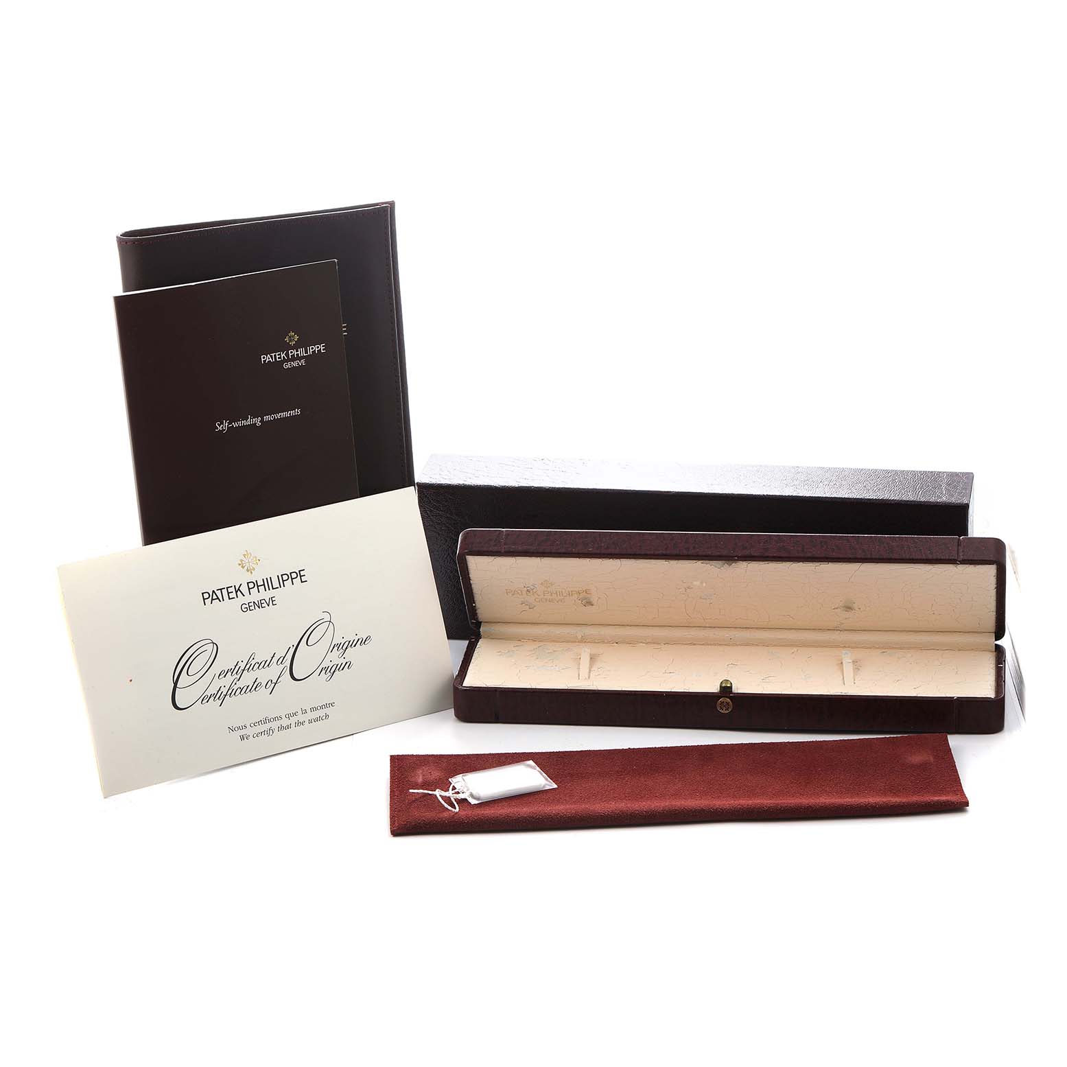 The image shows the Patek Philippe Gondolo 5030R Men's Rose Gold Silver Dial watch accessories, including a case, certificate, and a booklet, viewed from above.